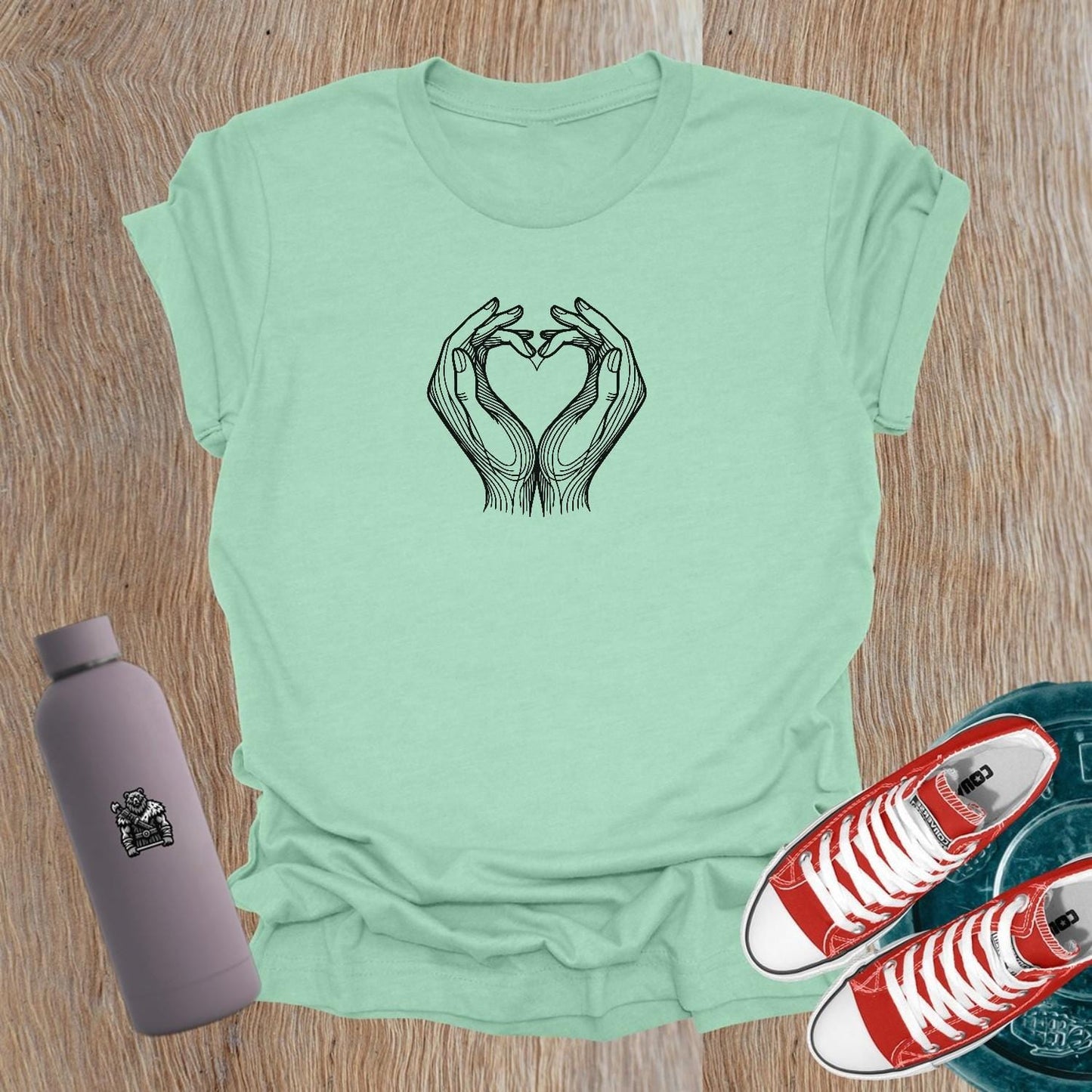 Empowering women's gym T-shirt featuring a heart-shaped hand graphic, symbolizing strength and passion for fitness and lifting weights.