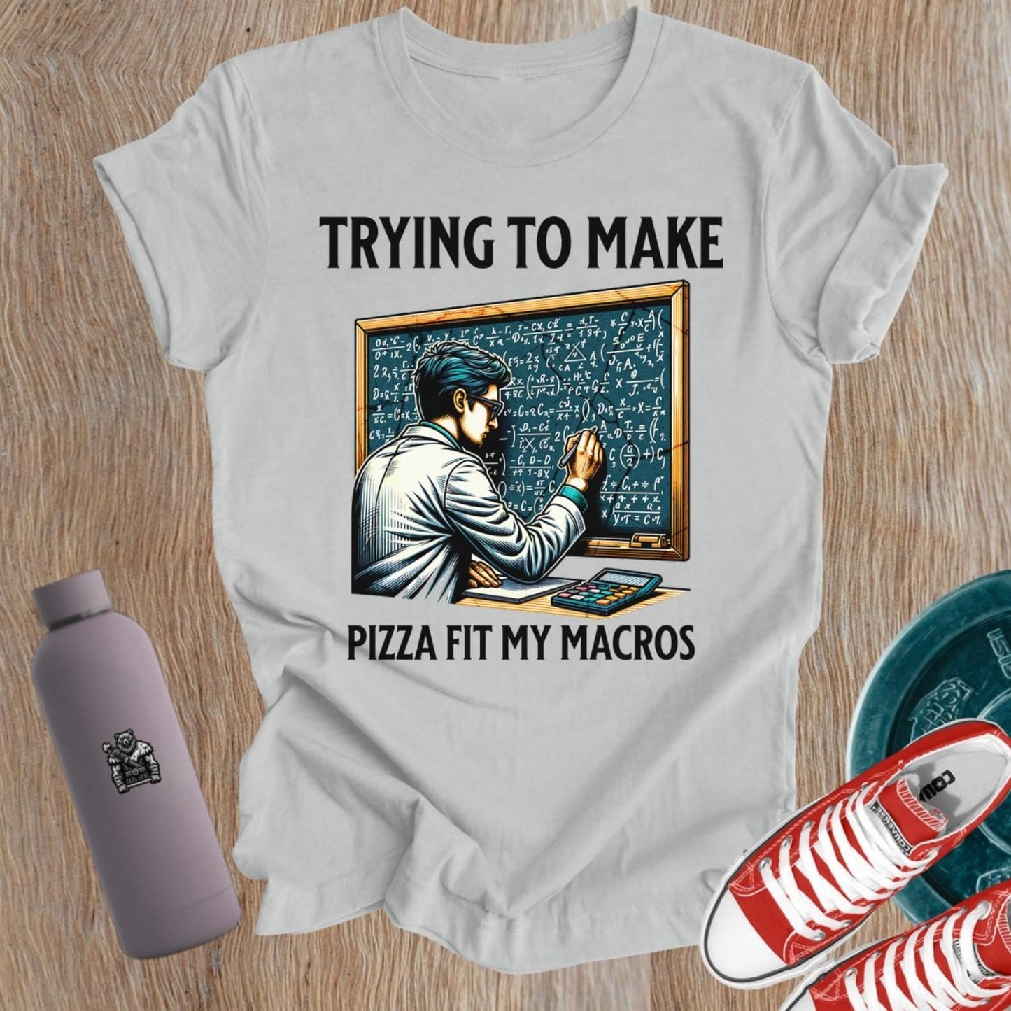 Alt text: "A humorous women’s fitness T-shirt featuring the phrase 'Trying to Make Pizza Fit My Macros'. Ideal for gym lovers, this playful design combines strength and balance, perfect for those who lift. Showcases a vibrant graphic, inspiring fitness journeys and conversations at the gym."