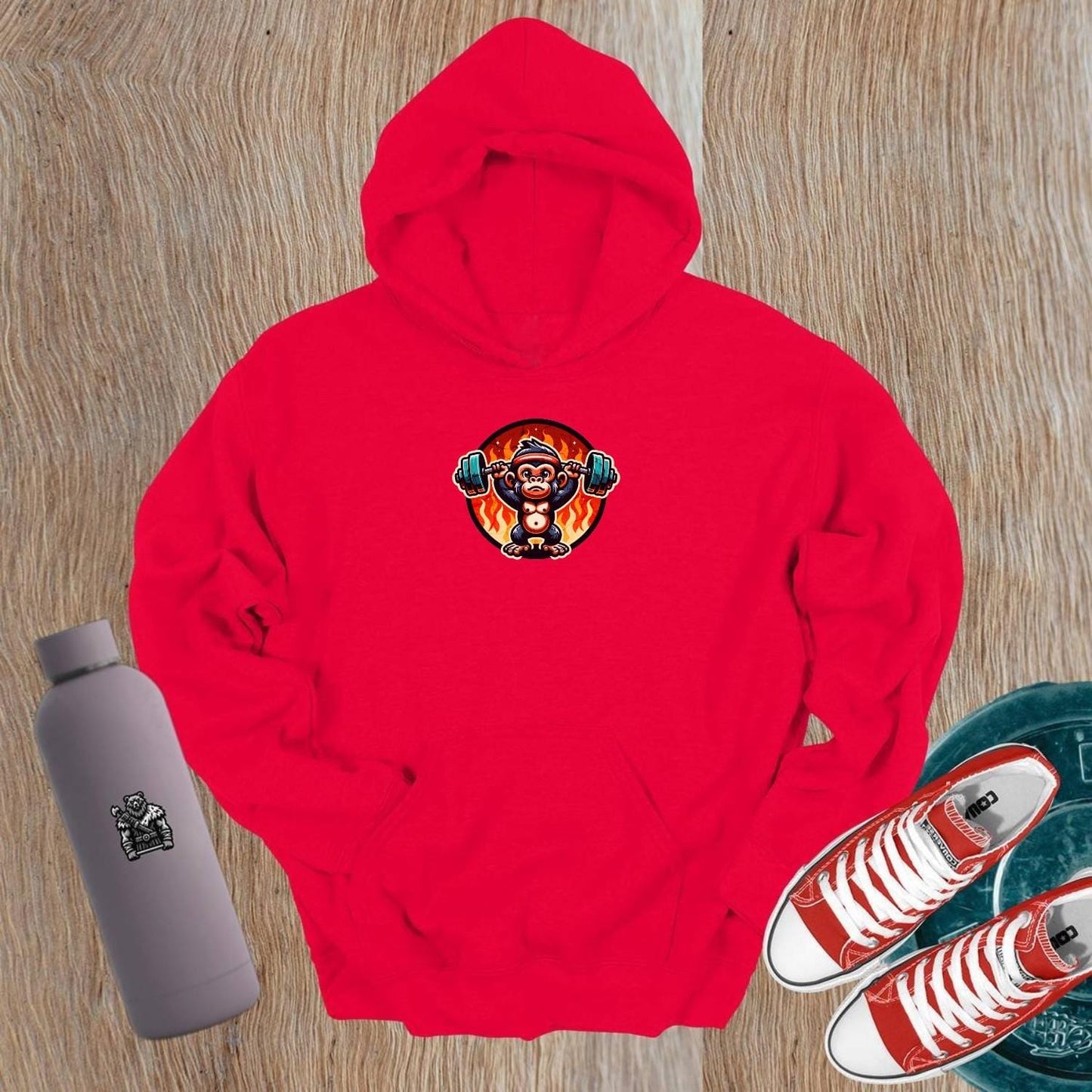 "Dynamic gym hoodie featuring a muscular monkey lifting weights against a fiery backdrop, showcasing style and strength for fitness enthusiasts."