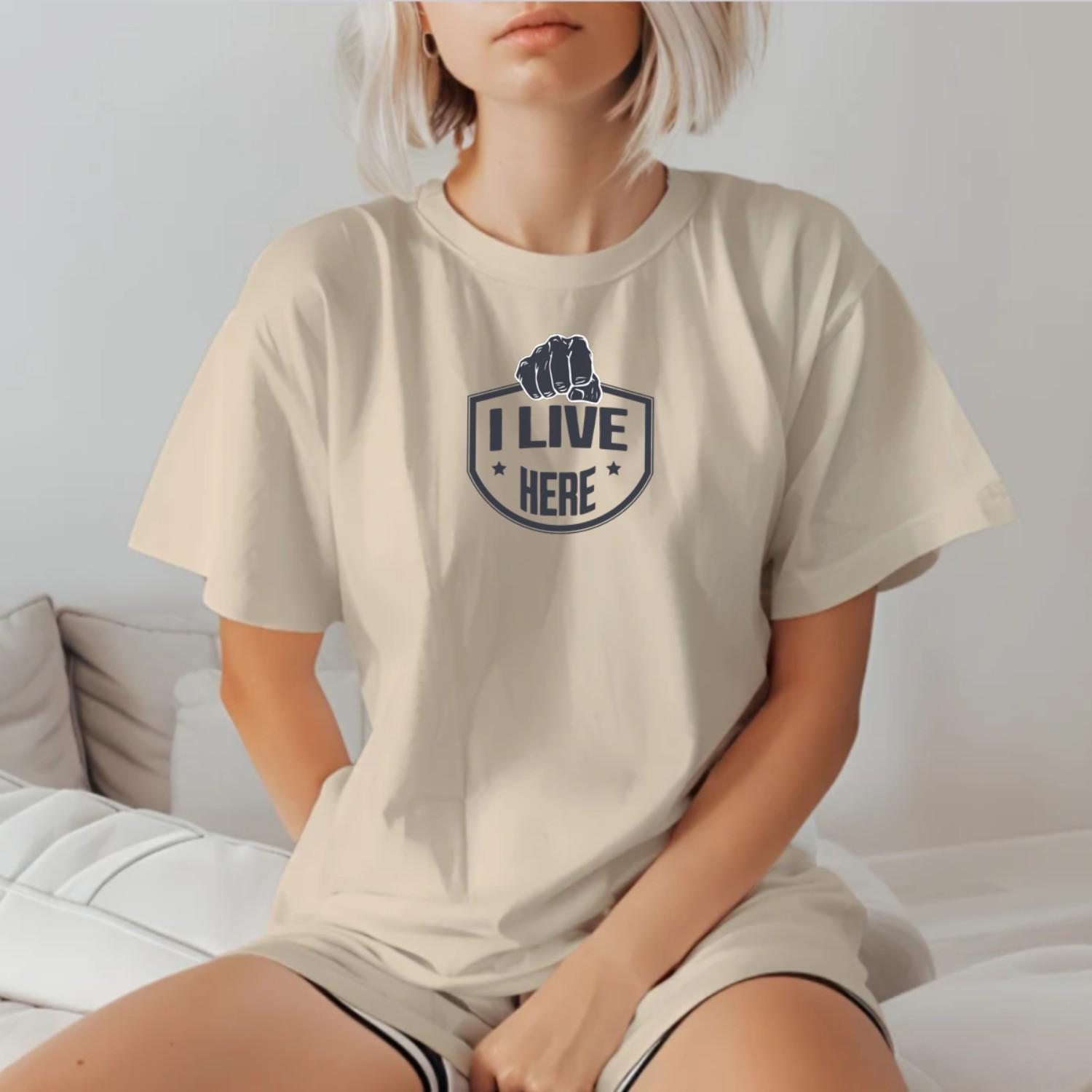 "Bold 'I Live Here' graphic tee for fitness enthusiasts, perfect for workouts and casual wear. Show your dedication to fitness!"