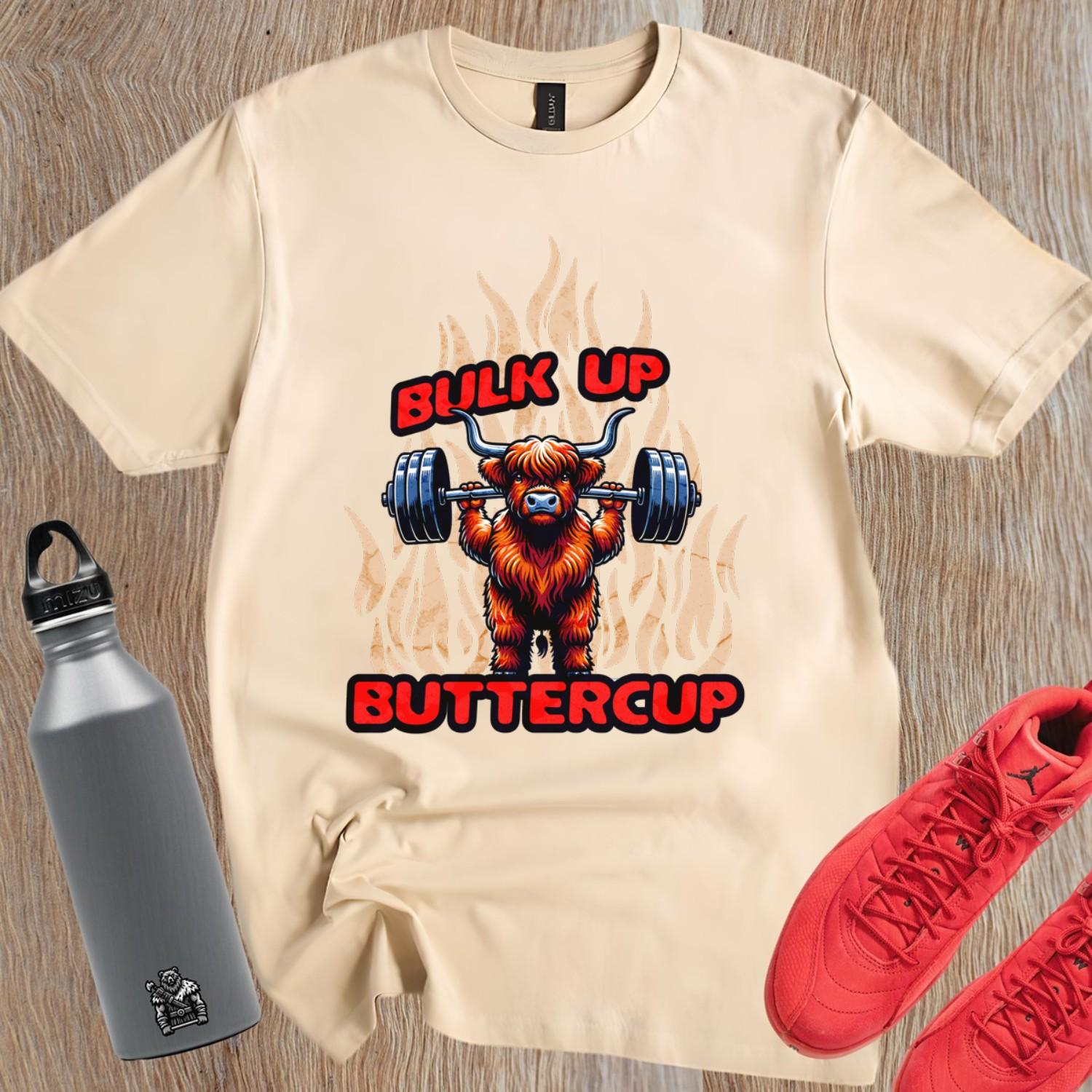 Alt text: "Bulk Up Buttercup T-shirt featuring a fierce weightlifting Highland cow surrounded by vibrant flames, perfect for gym enthusiasts."