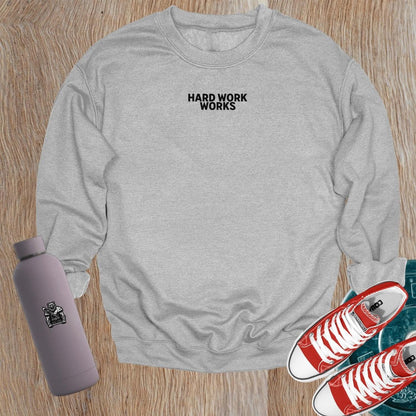 "Hard Work Works gym sweatshirt featuring a motivational graphic, perfect for layering pre- or post-workout, blending style and comfort."