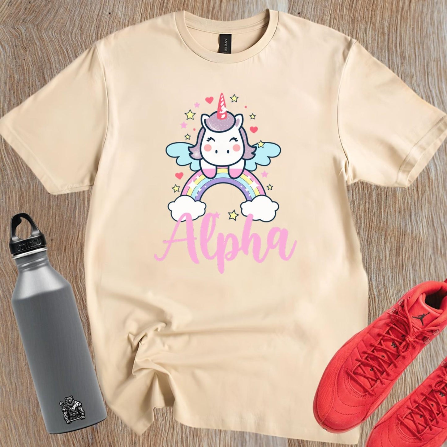 "Colorful Alpha T-shirt featuring a cute unicorn, rainbows, and sparkling stars, perfect for gym workouts and showcasing individuality."