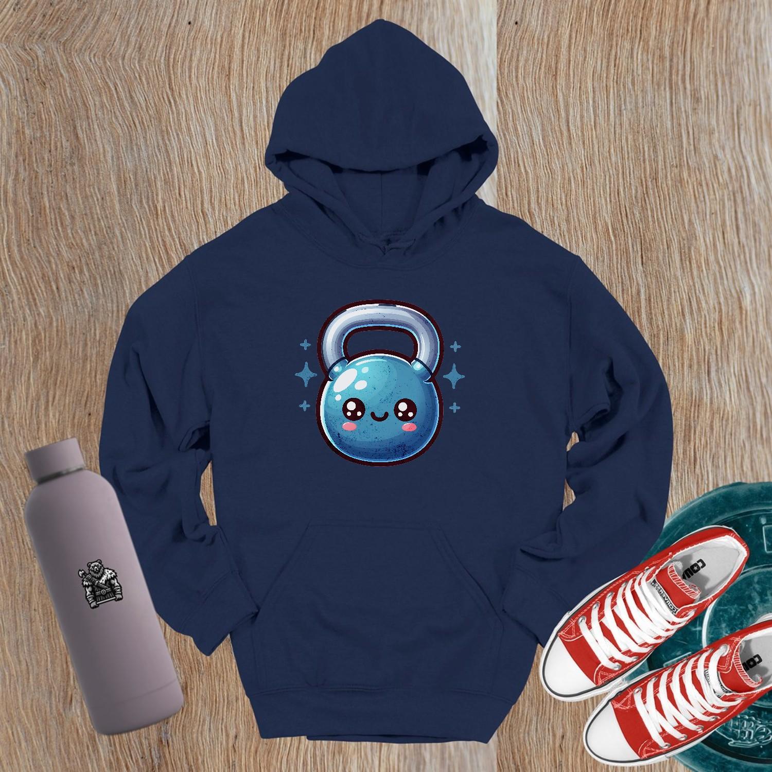 "Adorable fitness hoodie featuring a smiley kettlebell graphic, perfect for workouts or casual wear. Stylish and cozy gym apparel."