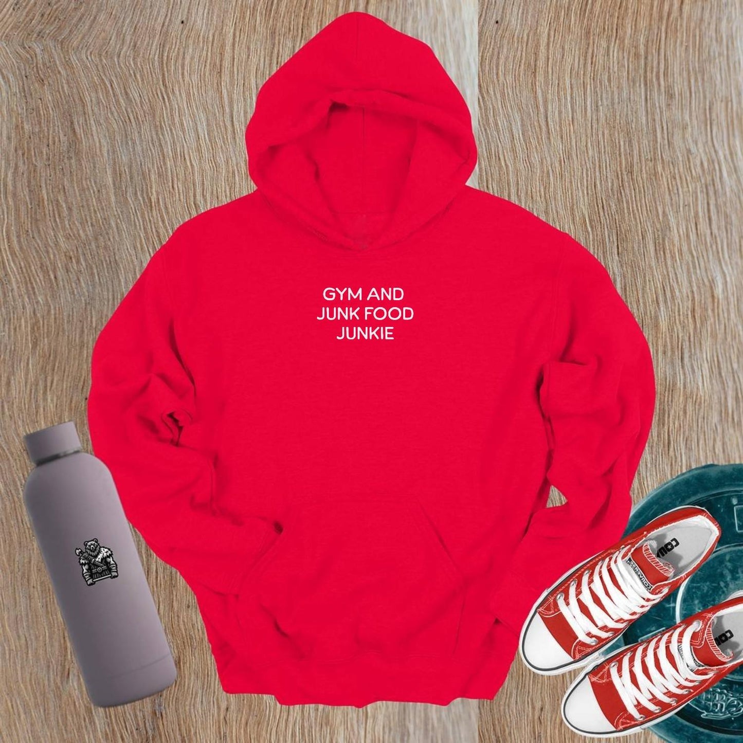 "Stylish 'Gym and Junk Food Junkie' hoodie featuring bold text, perfect for fitness lovers balancing workouts and indulgent treats."