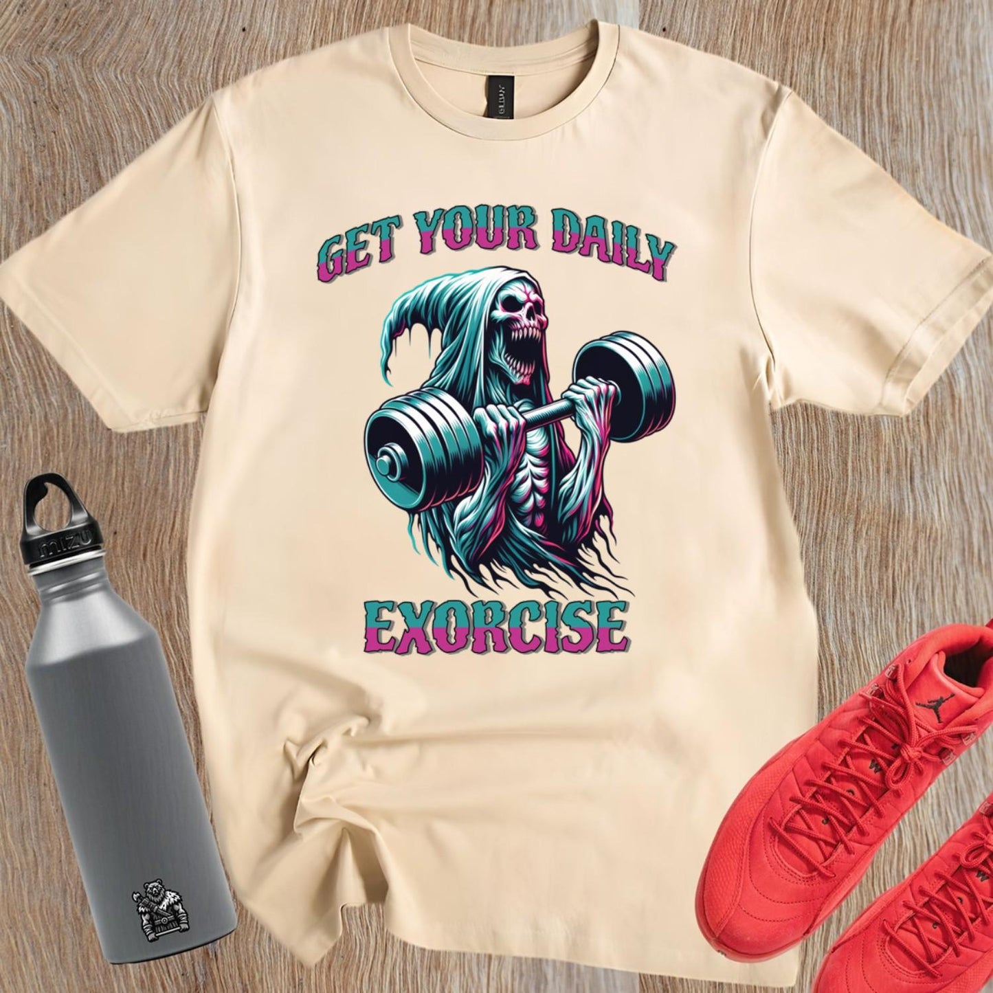 "Muted black T-shirt featuring a striking graphic of a skeleton lifting weights, promoting fitness motivation with a quirky style."
