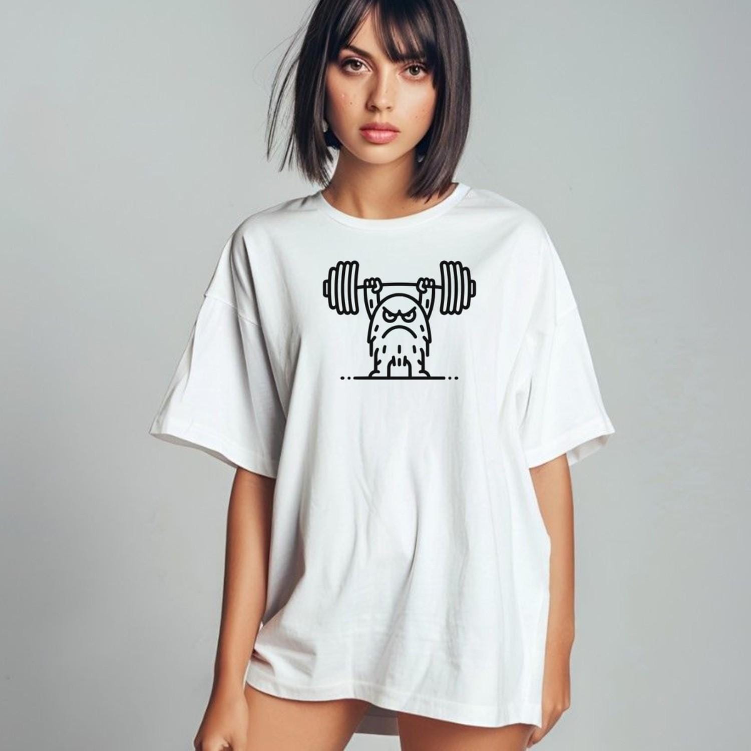 "Graphic T-shirt featuring a fierce creature lifting weights, perfect for gym enthusiasts. Motivational, stylish workout apparel design."