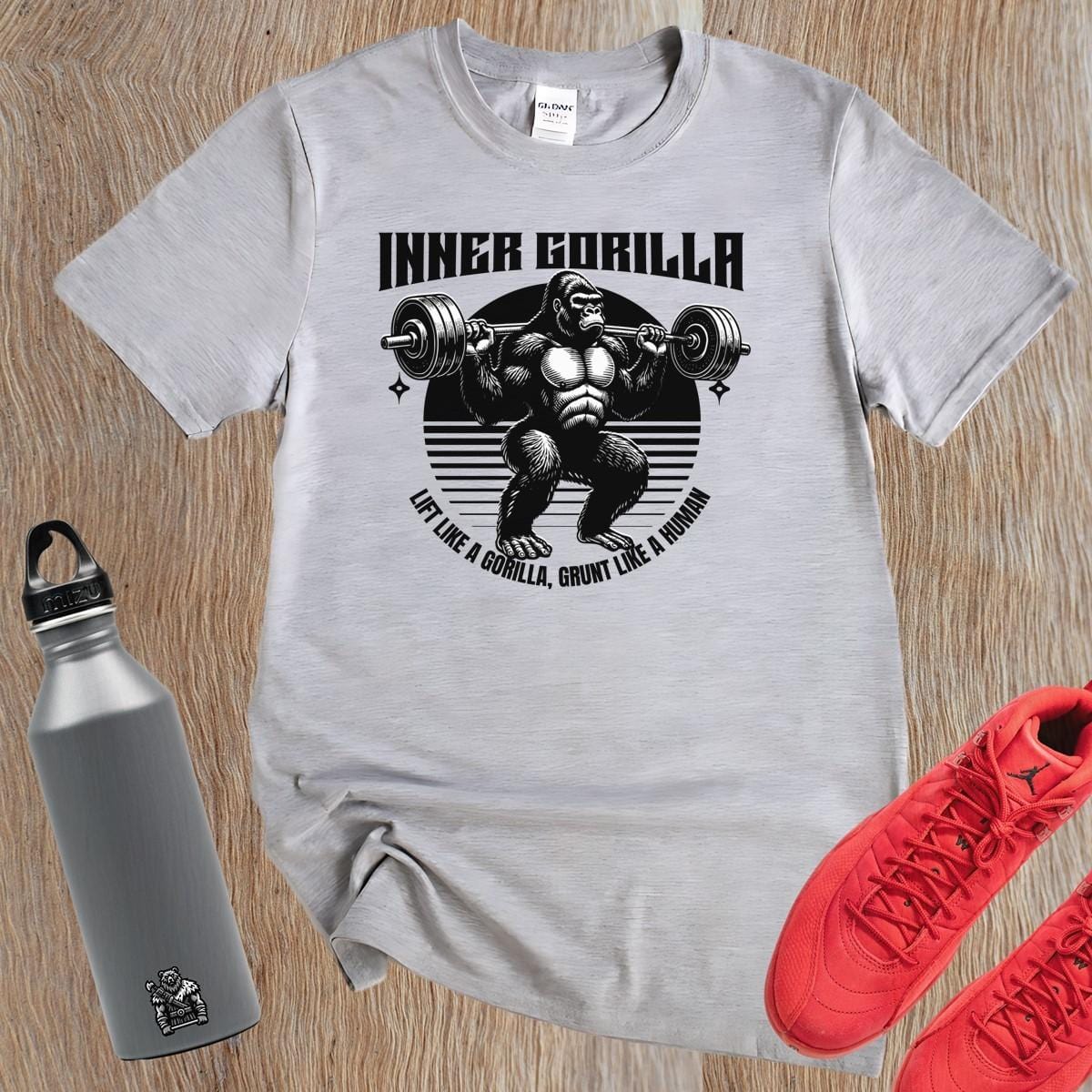 Alt text: "Gorilla Gym T-Shirt featuring a bold graphic of a powerful gorilla lifting weights, symbolizing strength and fitness motivation."