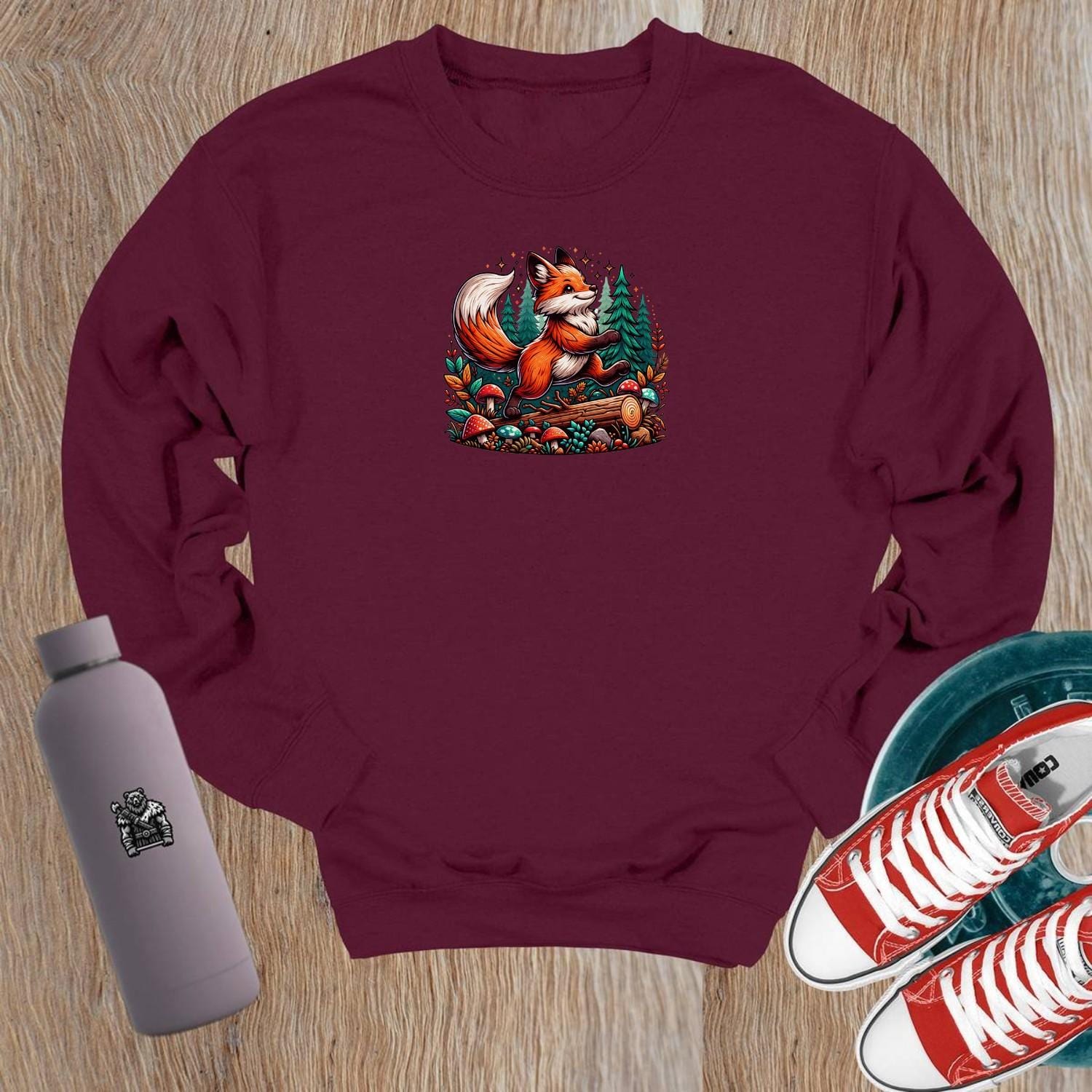 "Vibrant crewneck sweatshirt featuring a playful fox among lush trees and whimsical mushrooms, perfect for gym or casual outings."