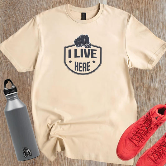 "Bold 'I Live Here' graphic tee for fitness enthusiasts, perfect for workouts and casual wear. Show your dedication to fitness!"