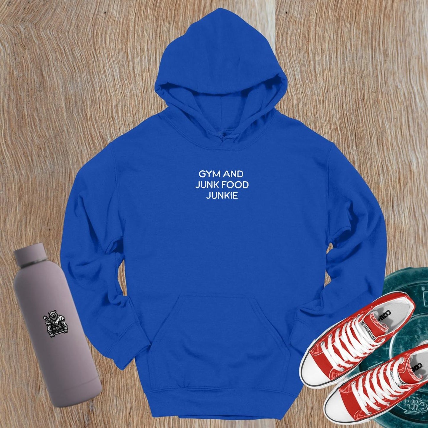 "Stylish 'Gym and Junk Food Junkie' hoodie featuring bold text, perfect for fitness lovers balancing workouts and indulgent treats."