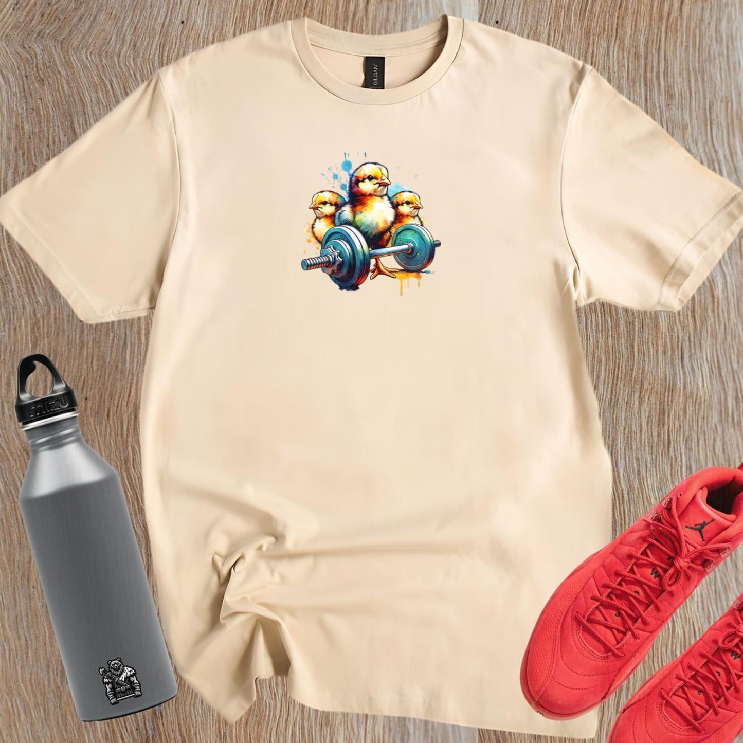 Playful gym T-shirt featuring vibrant chicks lifting weights, showcasing a fun, fierce spirit perfect for energetic workouts and fitness style.