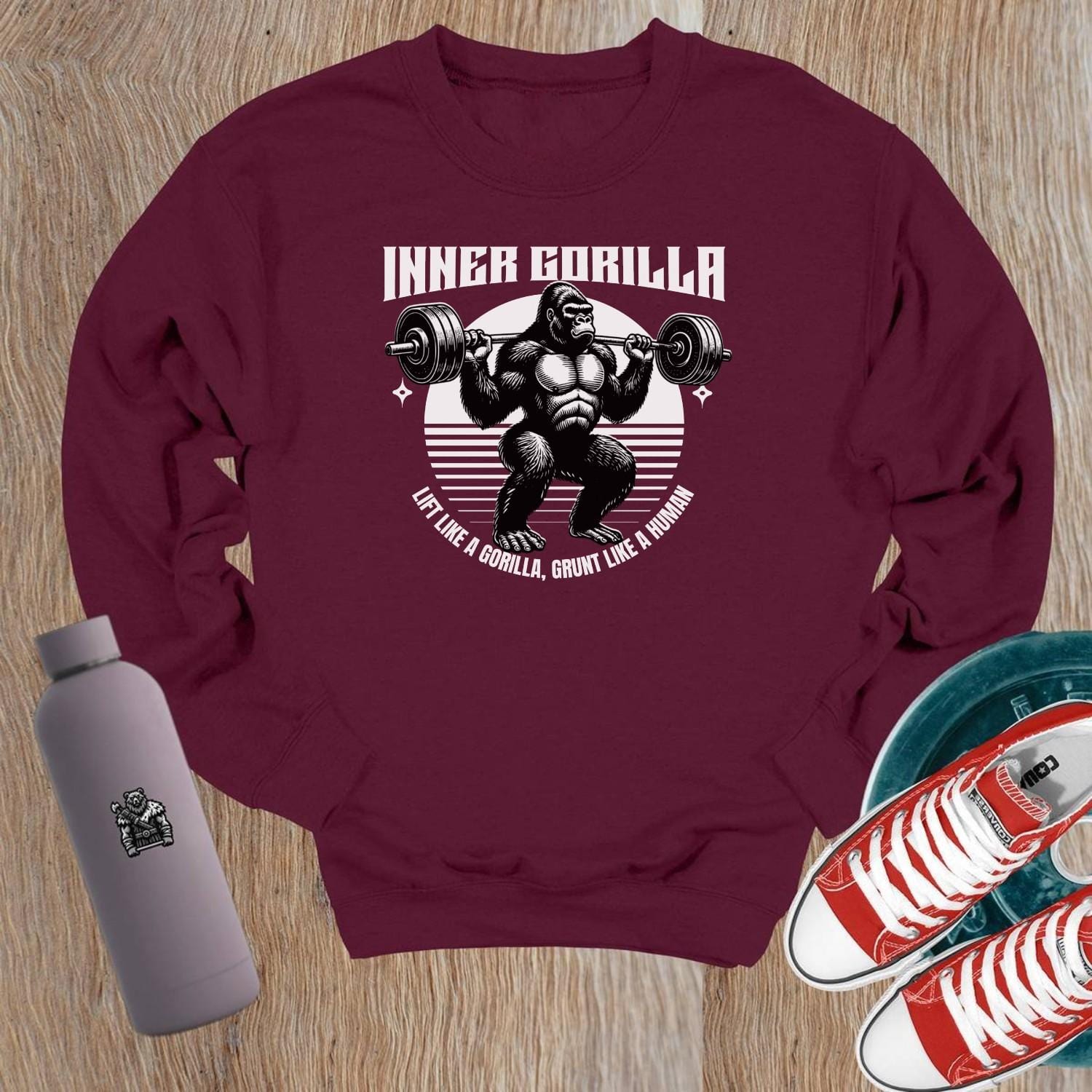 "Graphic crewneck sweatshirt featuring a powerful gorilla lifting weights with the motivational slogan 'Lift Like a Gorilla, Grunt Like a Human.' Ideal for fitness enthusiasts, this stylish gym apparel combines comfort and inspiration for workouts or casual wear."