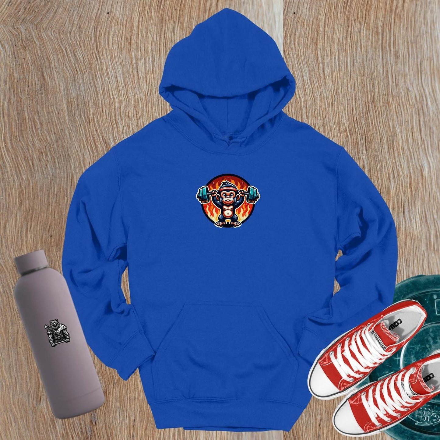 "Dynamic gym hoodie featuring a muscular monkey lifting weights against a fiery backdrop, showcasing style and strength for fitness enthusiasts."