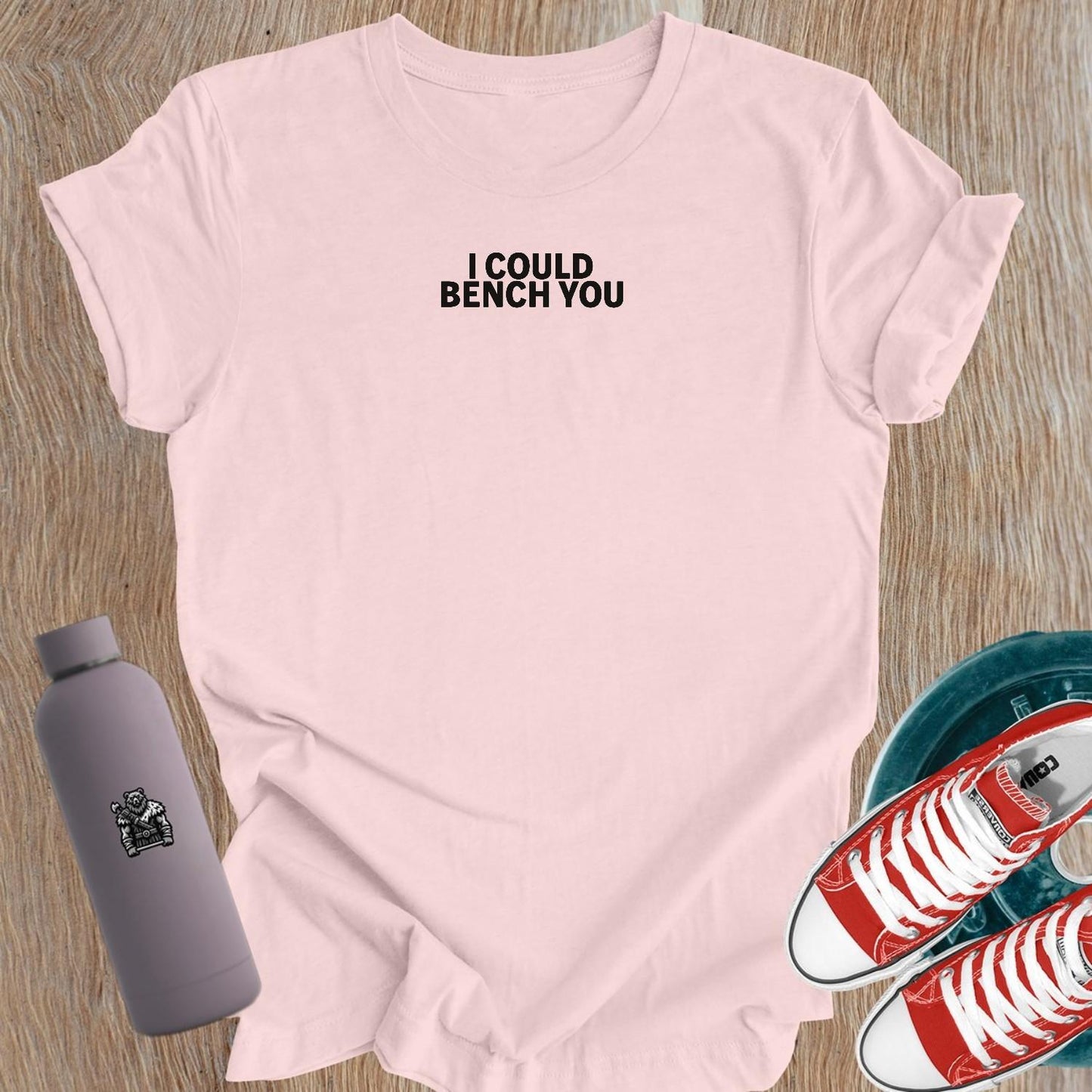 "Bold 'I Could Bench You' graphic on a flattering women's gym T-shirt, perfect for female lifters and fitness enthusiasts."