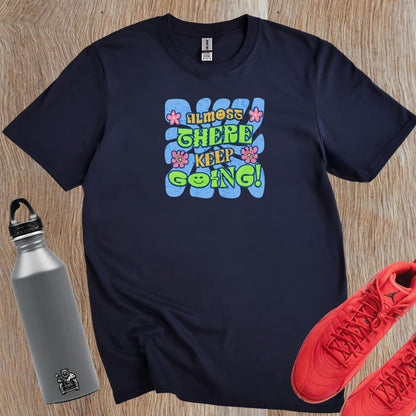 "Vibrant 'Almost There, Keep Going!' graphic gym T-shirt, featuring motivational design for fitness enthusiasts to inspire perseverance."