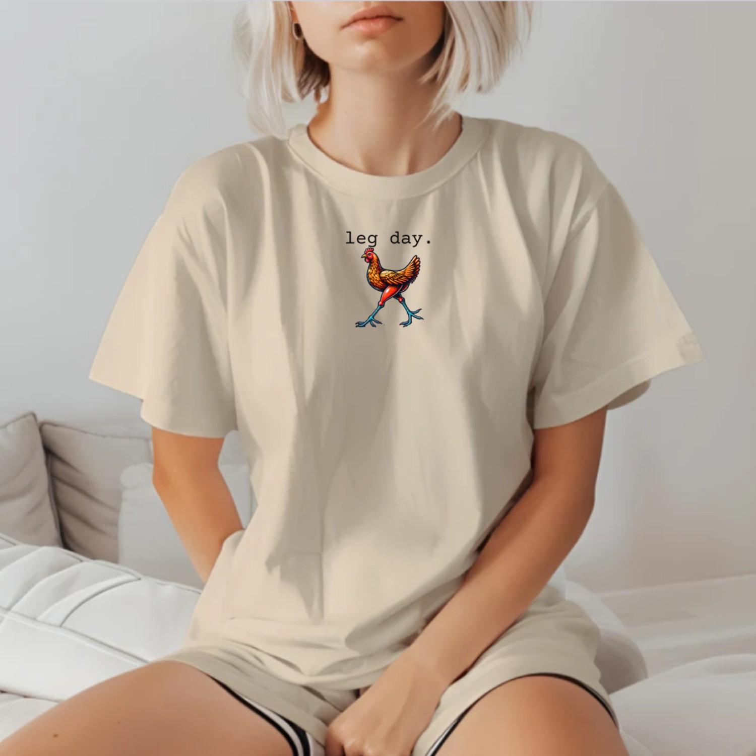 "Vibrant 'Leg Day' gym T-shirt featuring a playful chicken design, perfect for fitness enthusiasts seeking motivation and style."