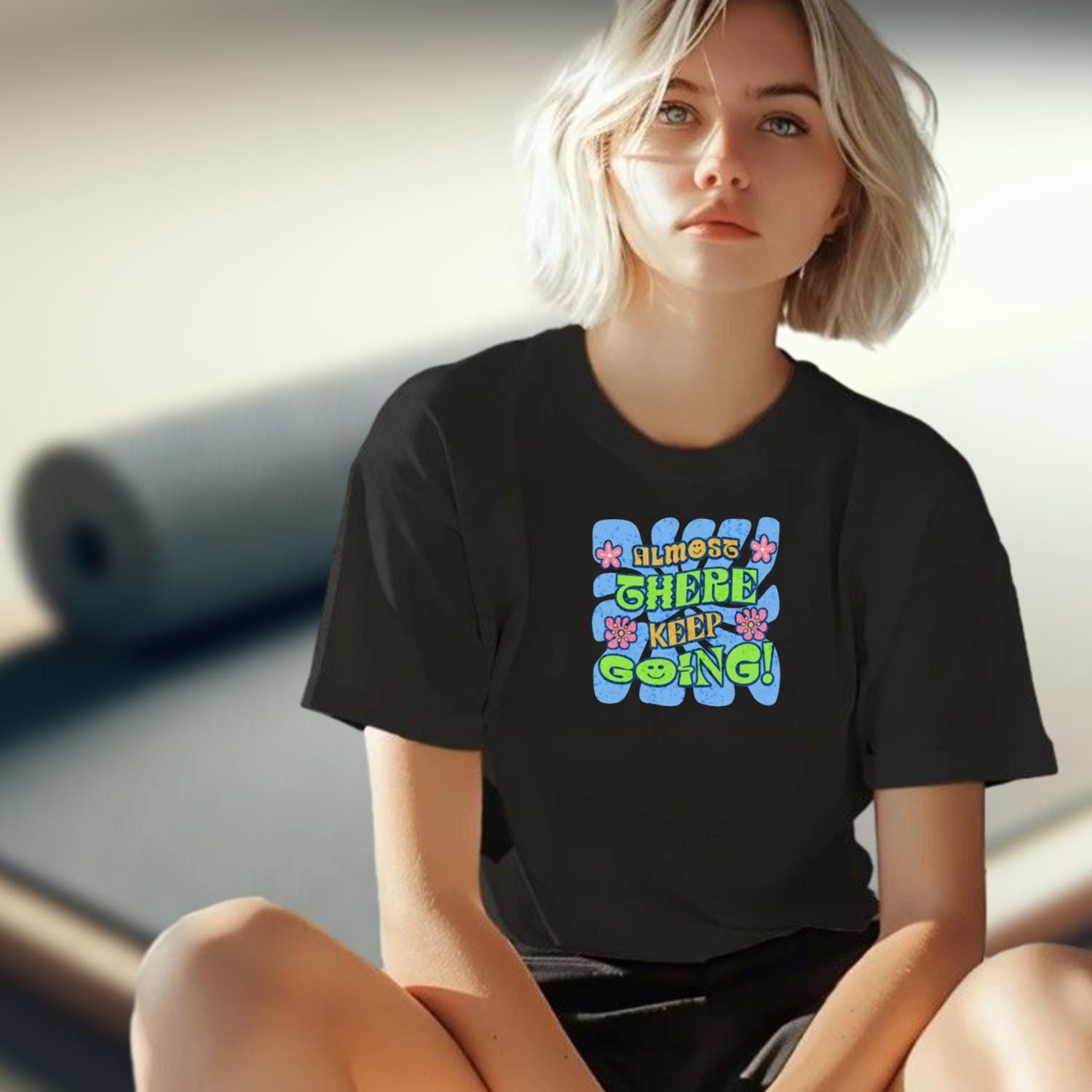 "Vibrant 'Almost There, Keep Going!' graphic gym T-shirt, featuring motivational design for fitness enthusiasts to inspire perseverance."