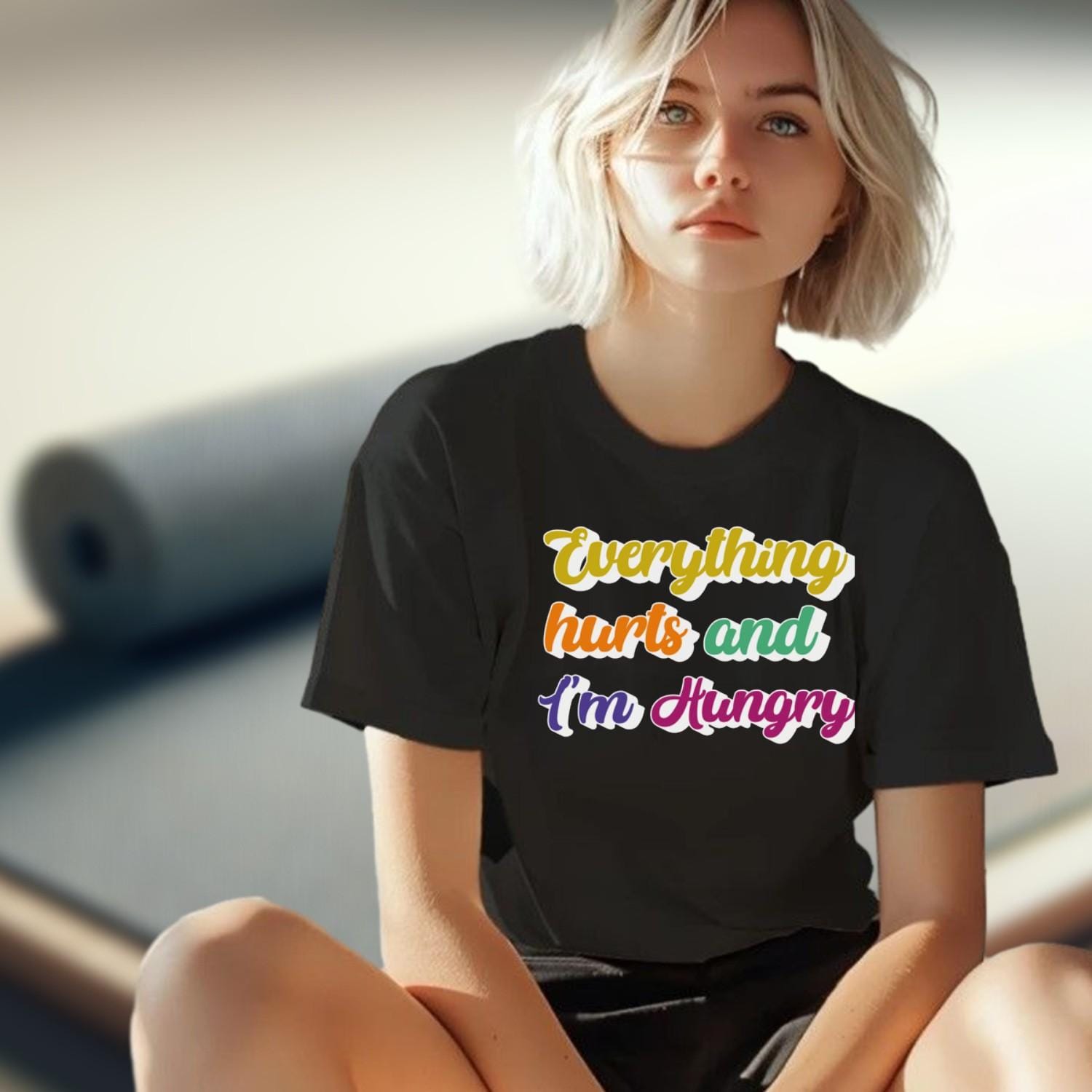 "Vibrant gym T-shirt reading 'Everything Hurts and I'm Hungry,' perfect for fitness enthusiasts who push their limits and crave results."