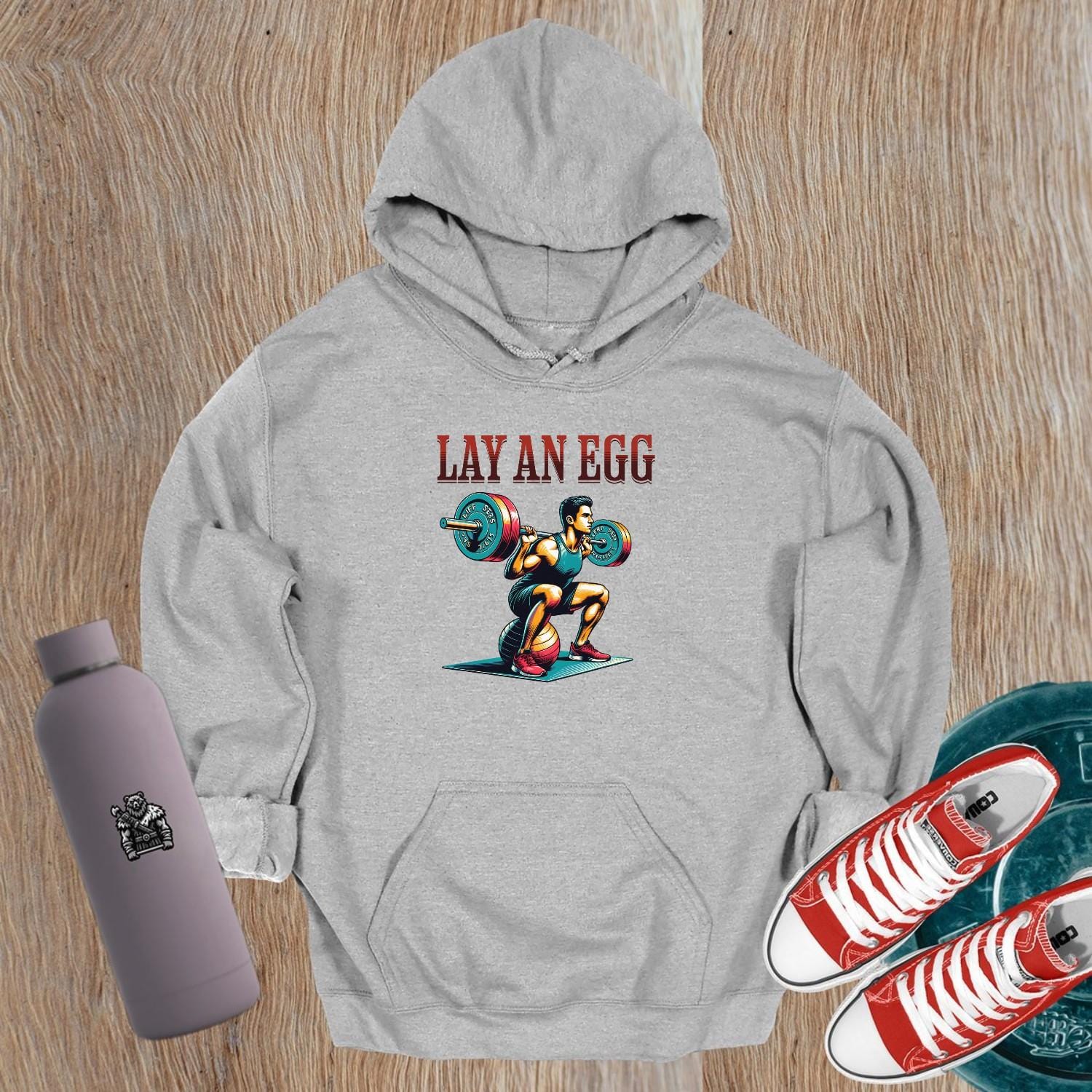 "Graphic gym hoodie featuring 'Lay an Egg' bold design, perfect for workouts and casual wear, inspiring strength and dedication."