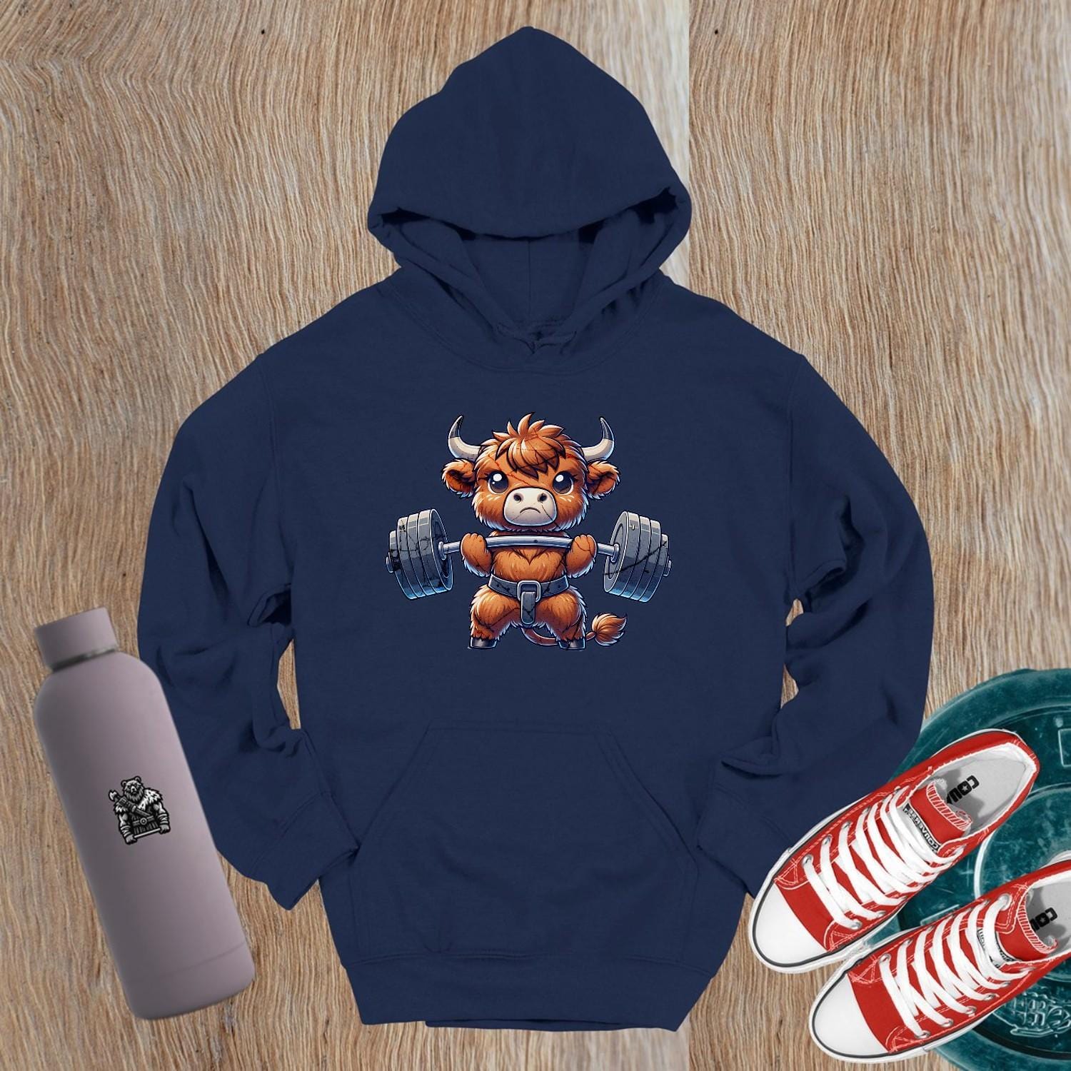 "Cartoon bull lifting weights on a stylish gym hoodie, embodying strength and motivation for gym enthusiasts and fitness lovers."