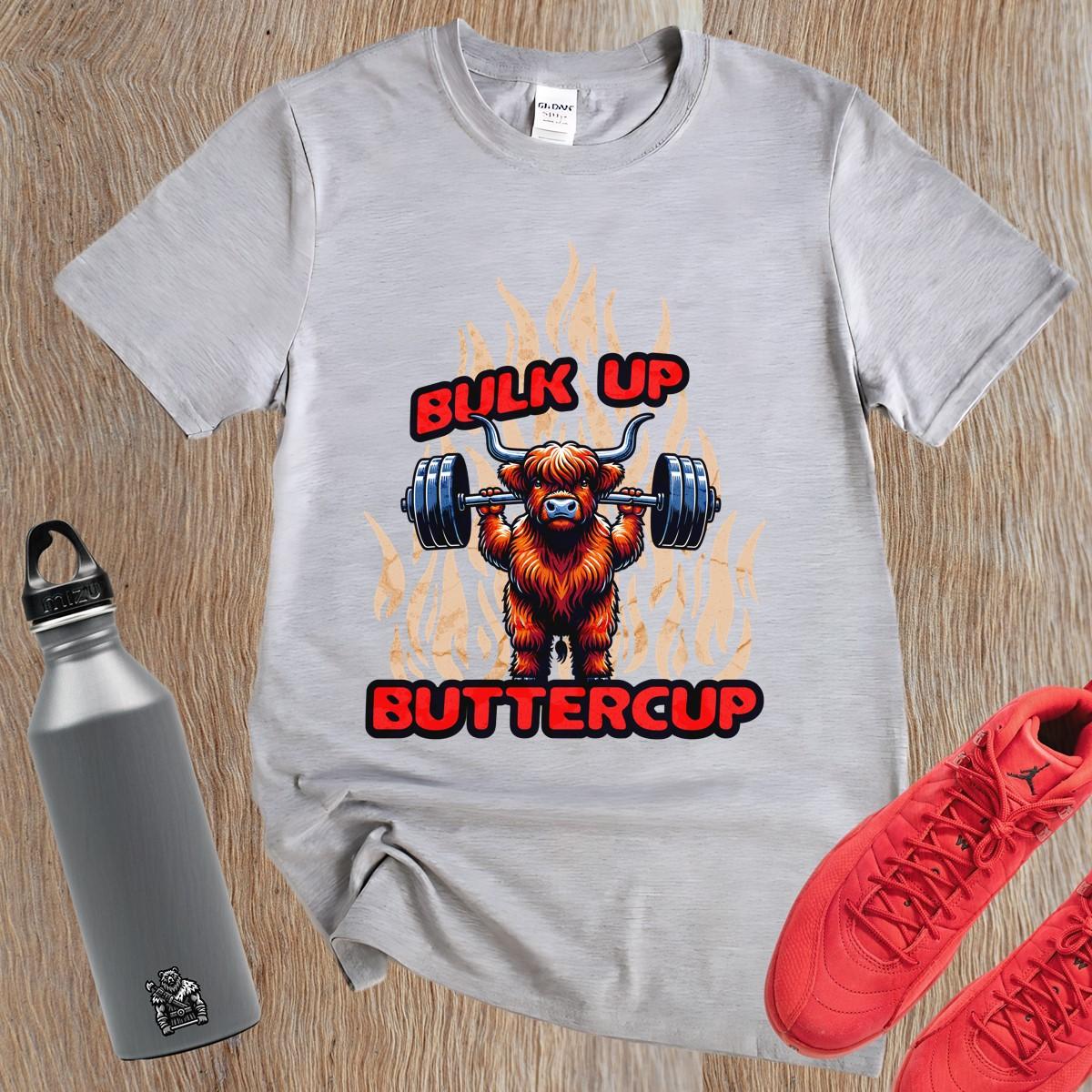 Alt text: "Bulk Up Buttercup T-shirt featuring a fierce weightlifting Highland cow surrounded by vibrant flames, perfect for gym enthusiasts."