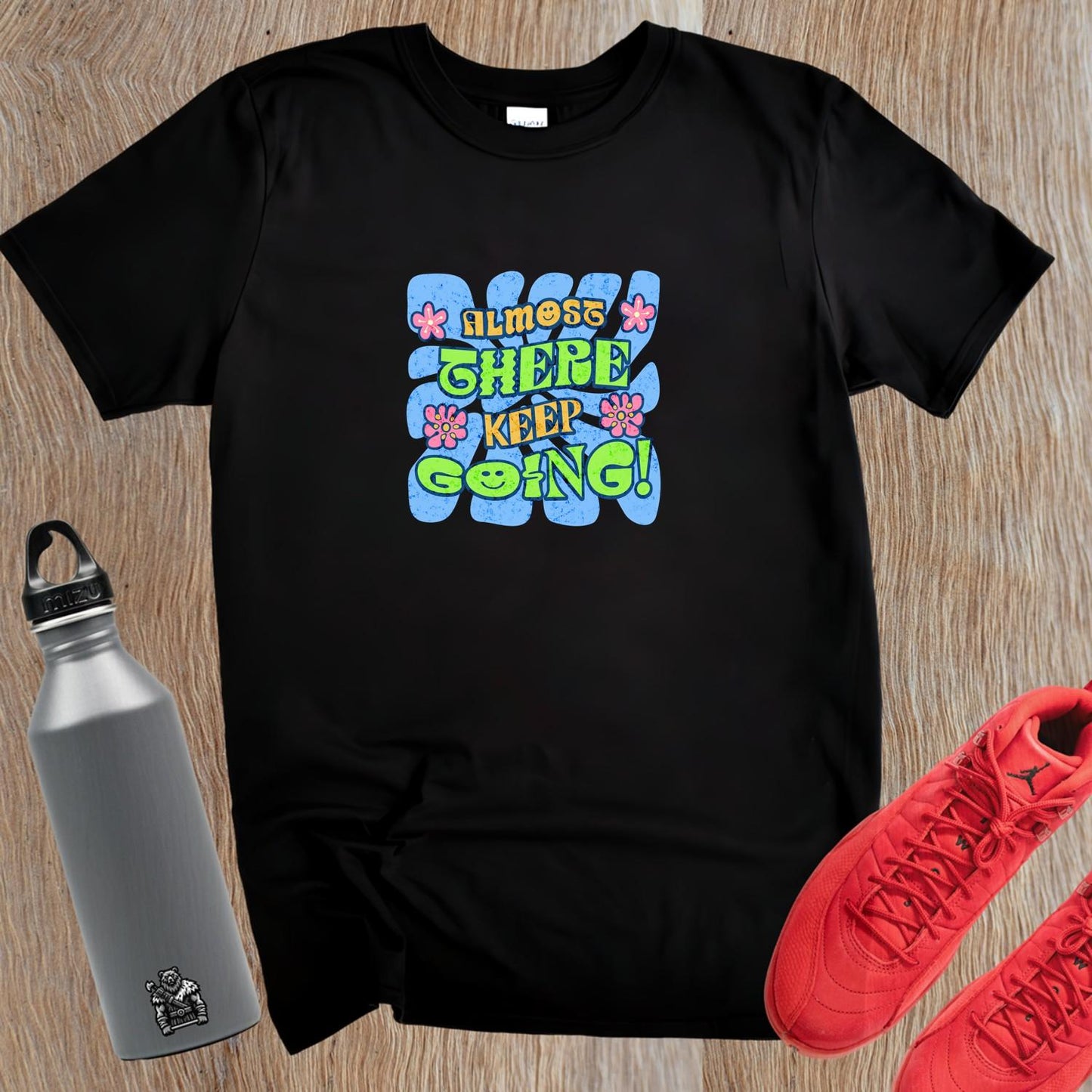 "Vibrant 'Almost There, Keep Going!' graphic gym T-shirt, featuring motivational design for fitness enthusiasts to inspire perseverance."