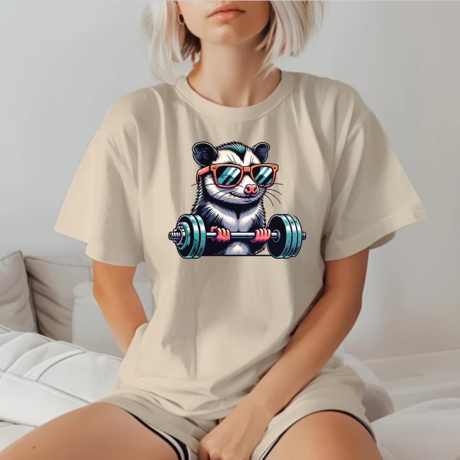 "Playful gym T-shirt featuring a cool possum lifting weights in stylish sunglasses, perfect for fitness enthusiasts and workout motivation."
