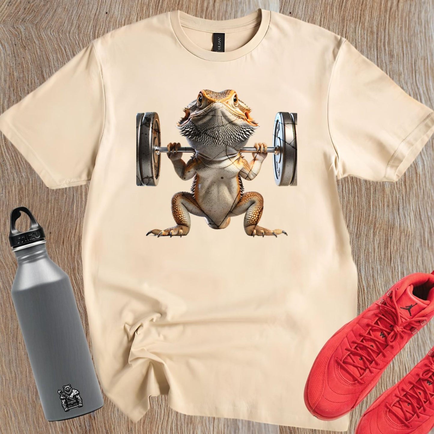 "Gym t-shirt featuring a vibrant lizard lifting weights, showcasing strength and individuality, ideal for gym enthusiasts and reptile lovers."