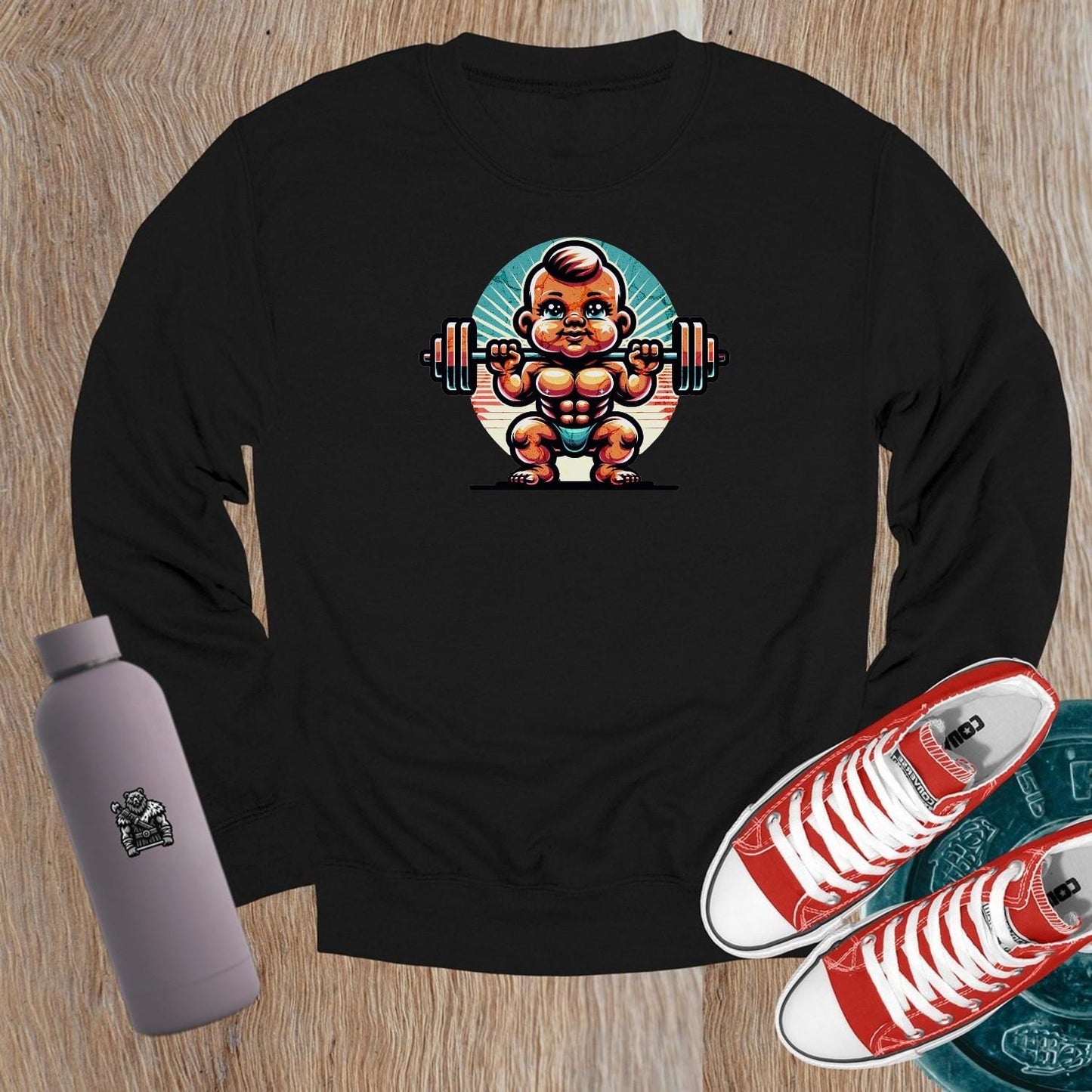 "Vibrant crewneck sweatshirt featuring a playful baby lifting weights graphic, perfect for gym enthusiasts and casual wear."