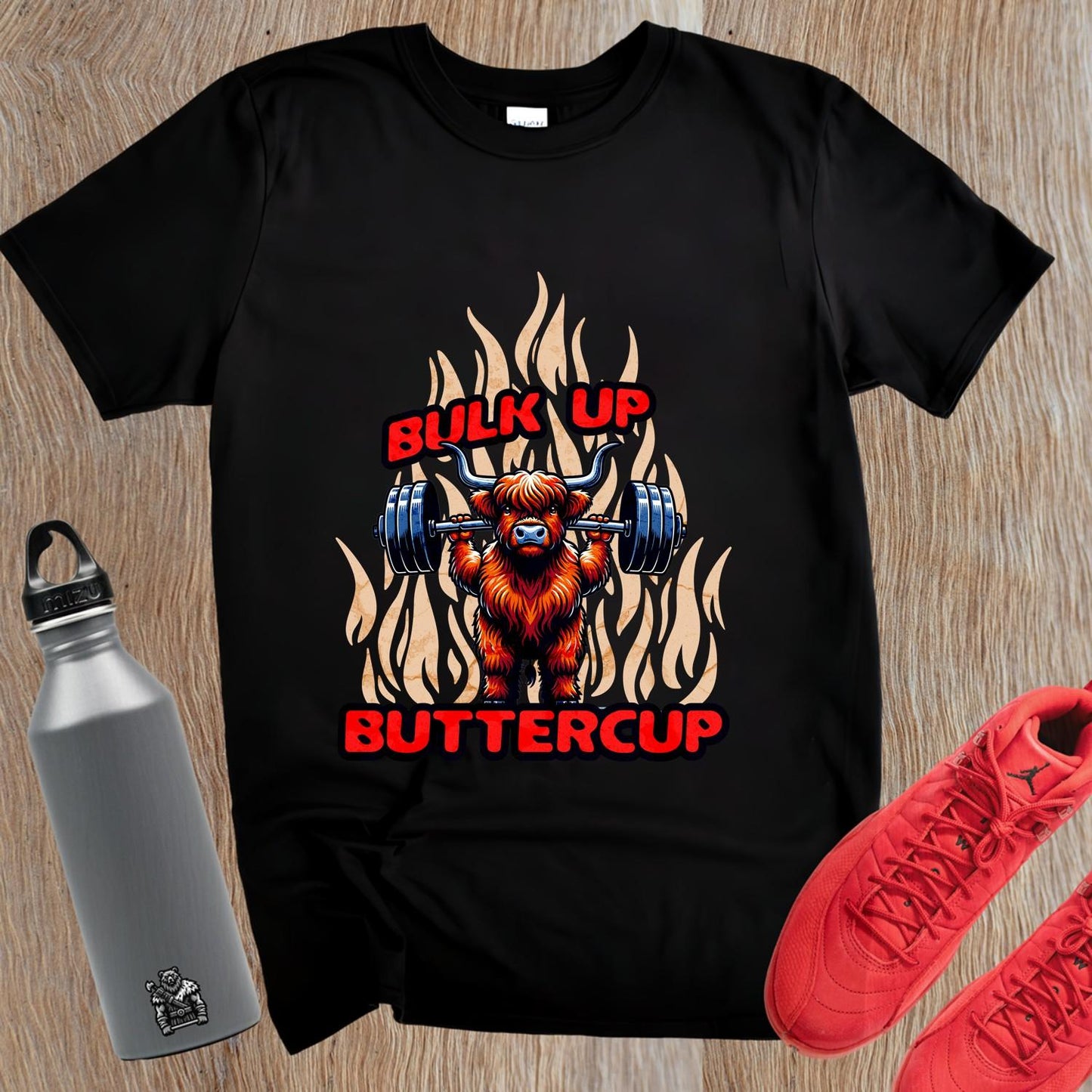 "Bulk Up Buttercup T-shirt featuring a playful lifted Highland cow design, perfect for motivational gym workouts and casual lifting."