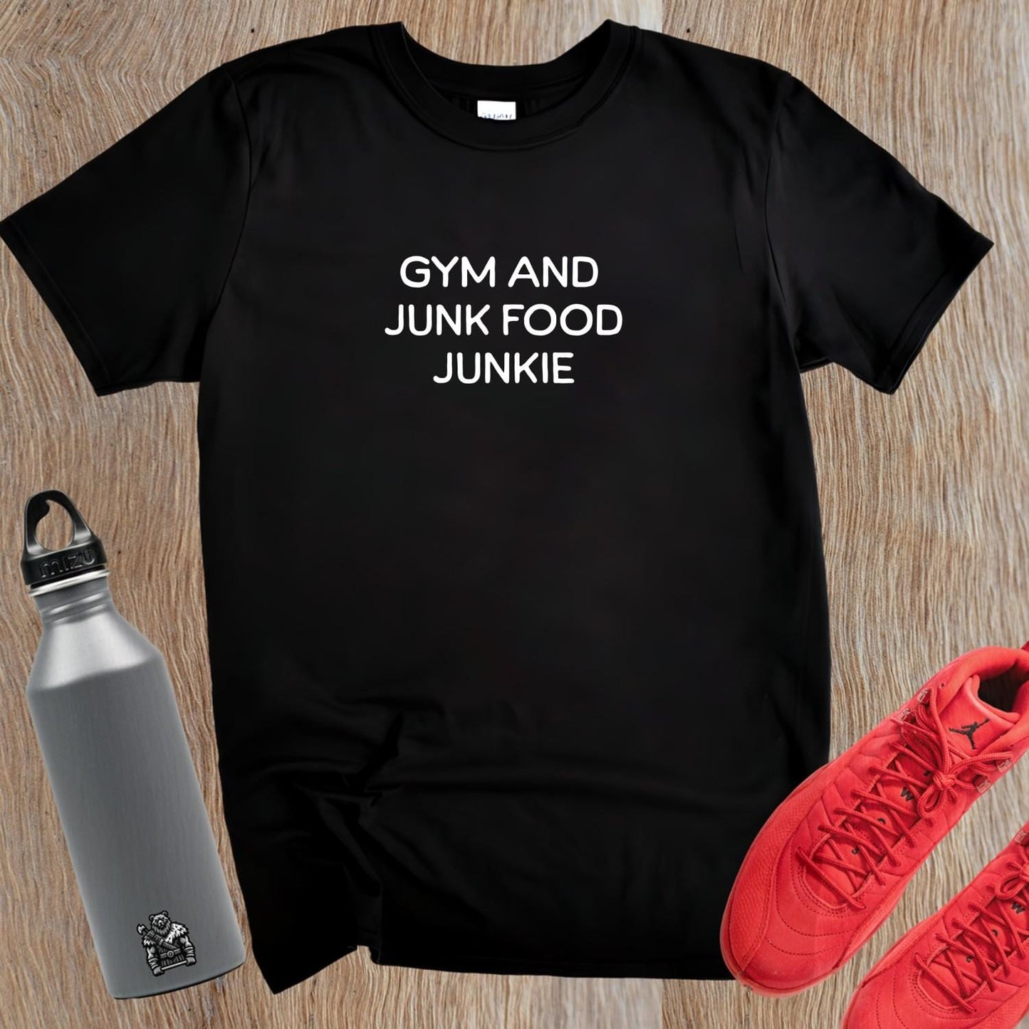 "Bold 'Gym and Junk Food Junkie' T-shirt design; perfect for fitness lovers embracing the balance of workouts and indulgence."