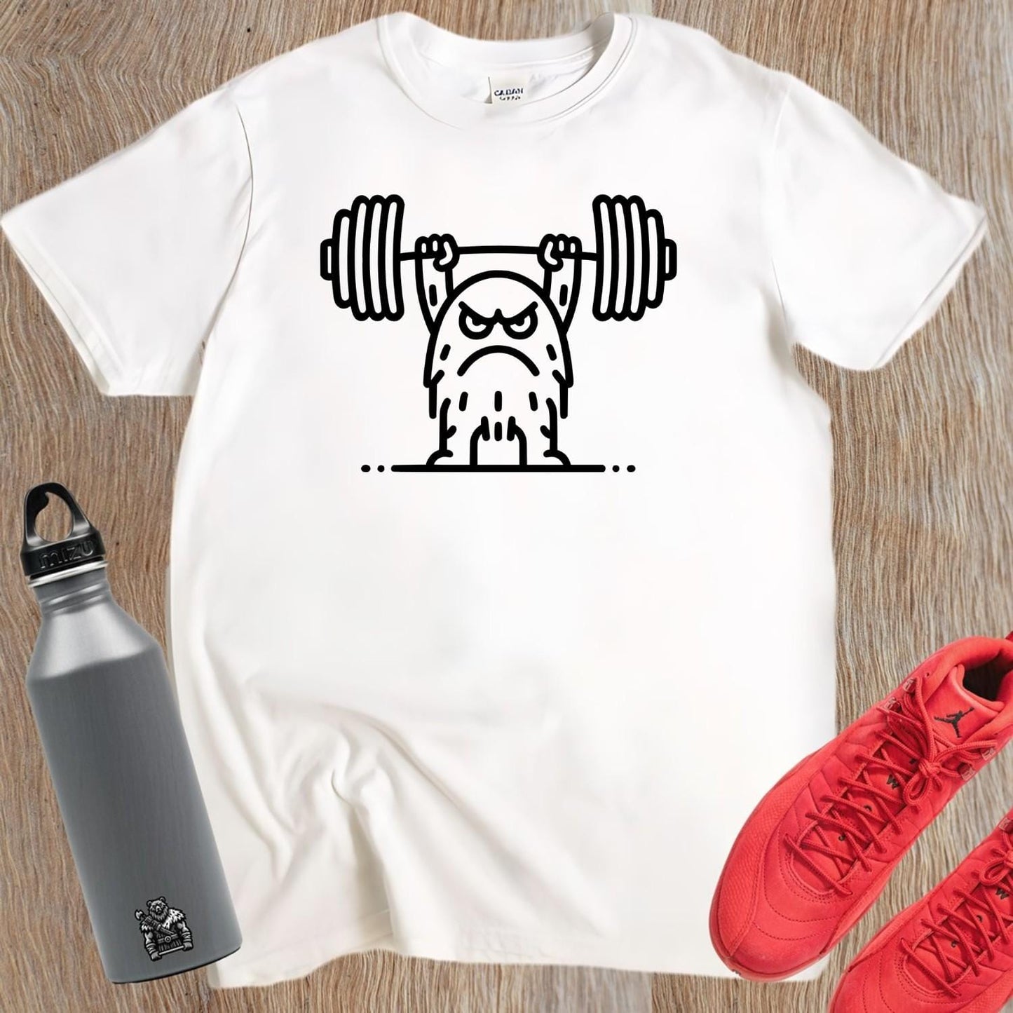 "Graphic T-shirt featuring a fierce creature lifting weights, perfect for gym enthusiasts. Motivational, stylish workout apparel design."