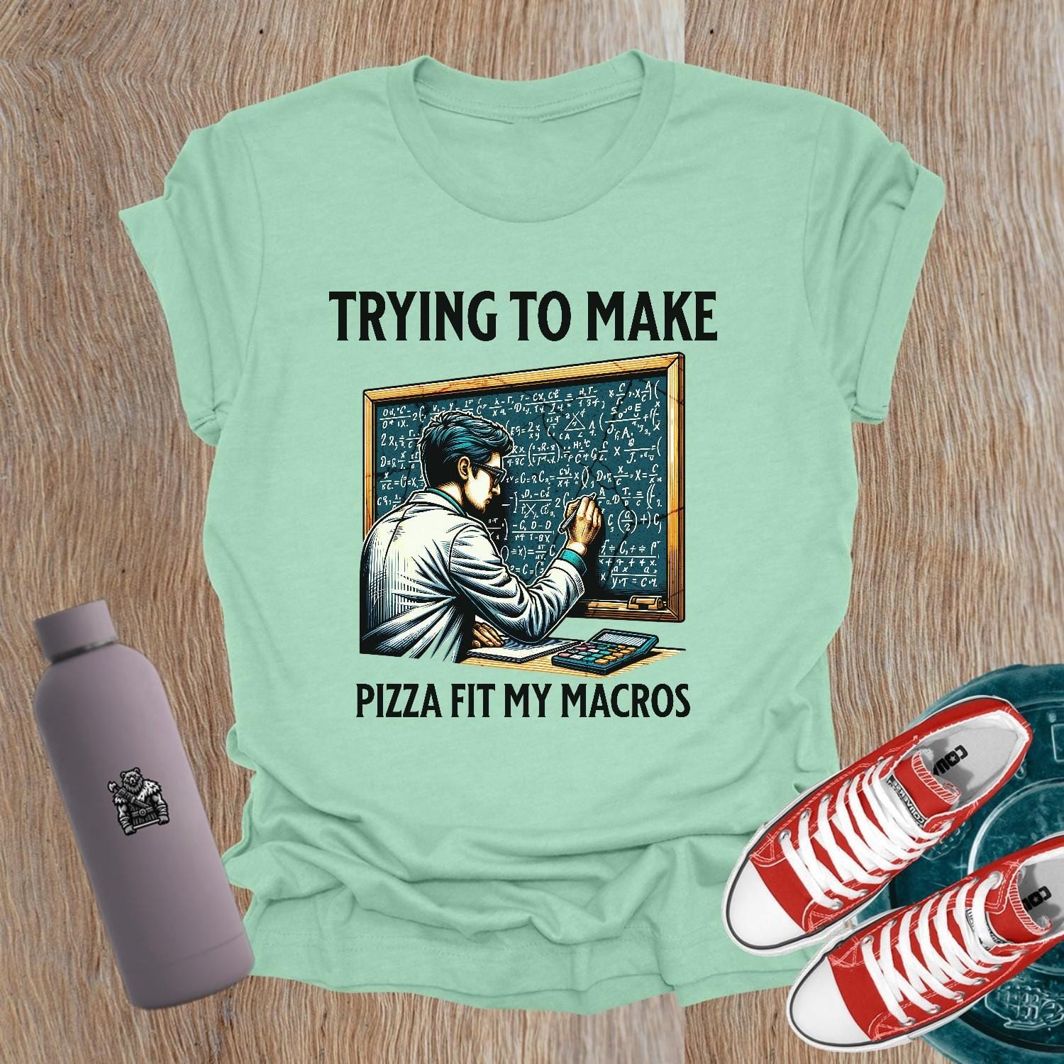 Alt text: "A humorous women’s fitness T-shirt featuring the phrase 'Trying to Make Pizza Fit My Macros'. Ideal for gym lovers, this playful design combines strength and balance, perfect for those who lift. Showcases a vibrant graphic, inspiring fitness journeys and conversations at the gym."