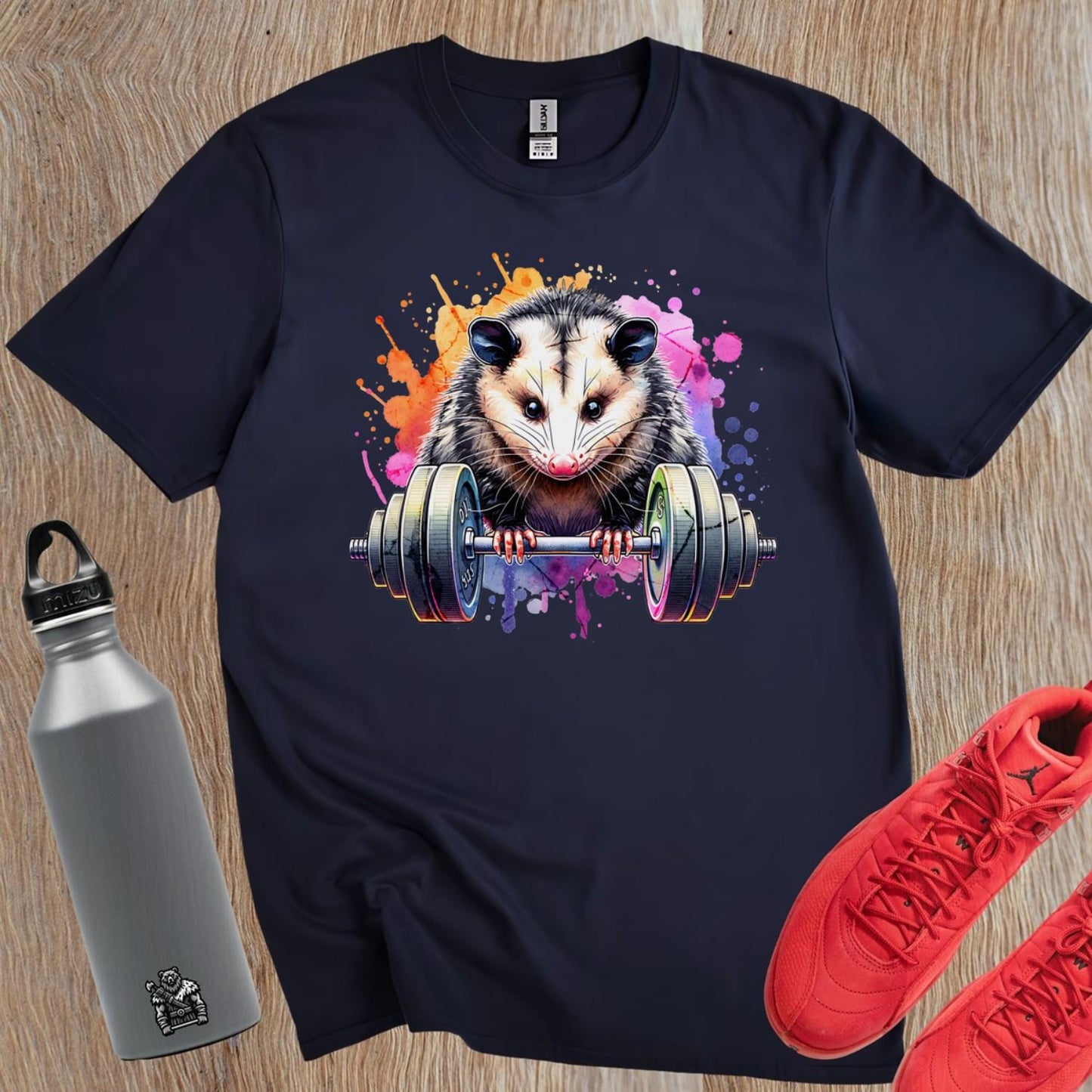 "Vibrant gym T-shirt featuring a playful opossum lifting weights, blending fitness and fun, perfect for workout enthusiasts."