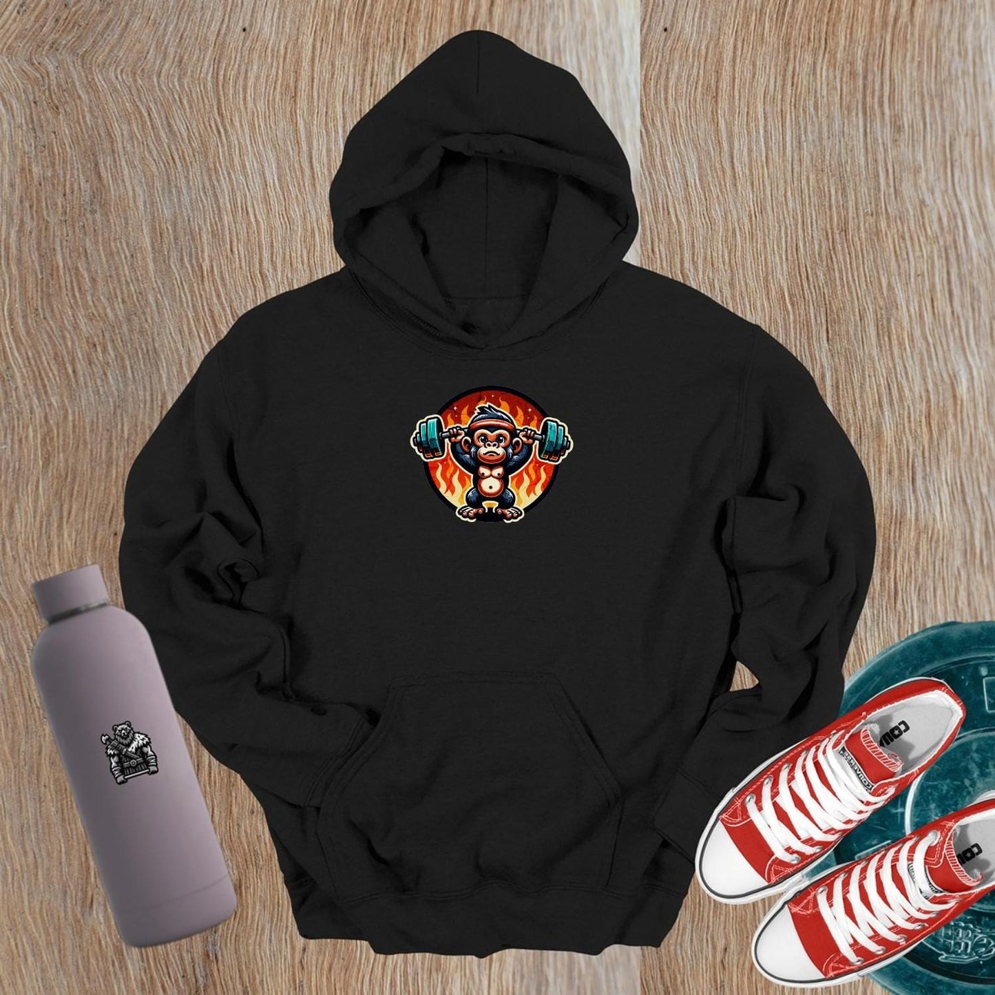 "Dynamic gym hoodie featuring a muscular monkey lifting weights against a fiery backdrop, showcasing style and strength for fitness enthusiasts."