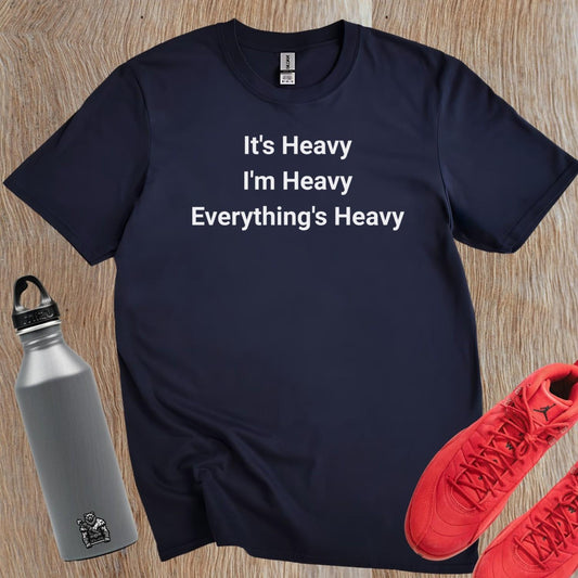 Alt text: "Bold black and white gym T-shirt featuring the motivational phrase 'It's Heavy, I'm Heavy, Everything's Heavy' for fitness enthusiasts."