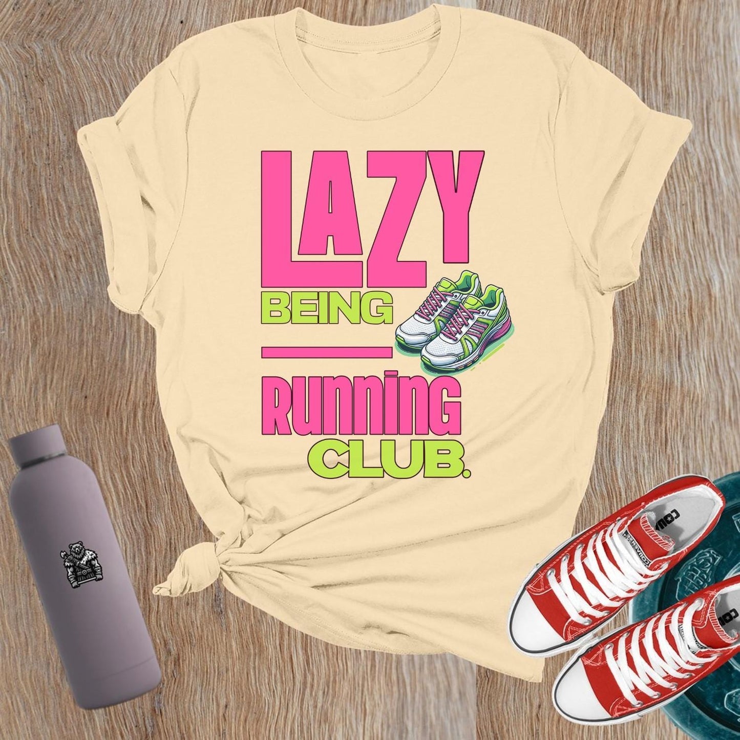 Alt text: "Fierce women's gym t-shirt featuring 'Lazy Being Running Club' bold graphic, perfect for lifting, workouts, and expressing strength."