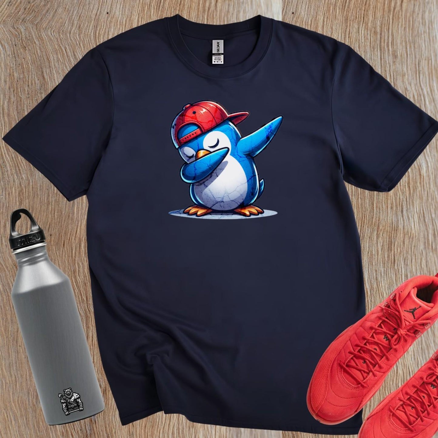 Alt text: "Vibrant gym T-shirt featuring a playful penguin wearing a cap, perfect for fitness enthusiasts who value comfort and style."
