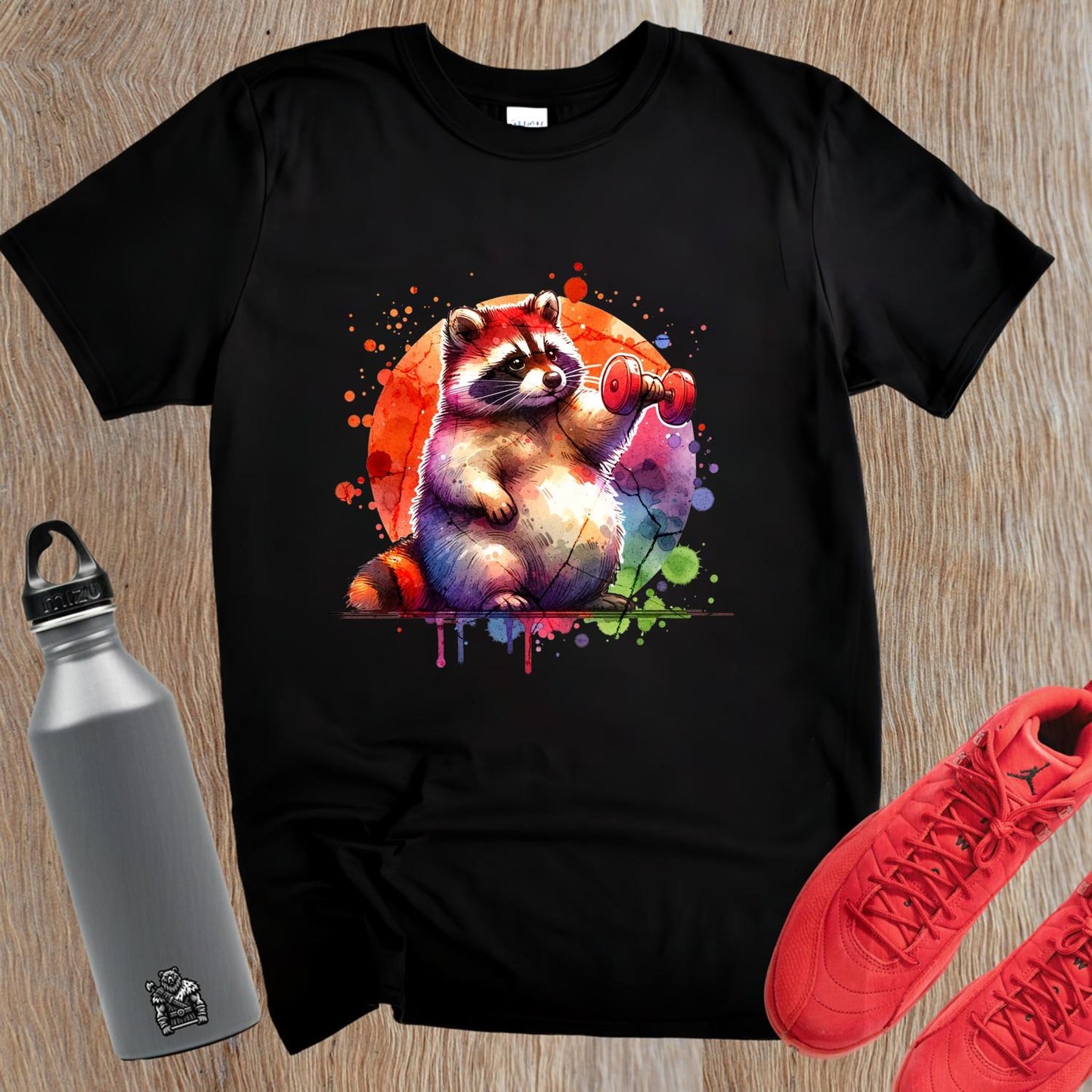 "Whimsical raccoon lifting weights on a vibrant gym T-shirt, perfect for fitness lovers and animal enthusiasts. Stylish workout attire."