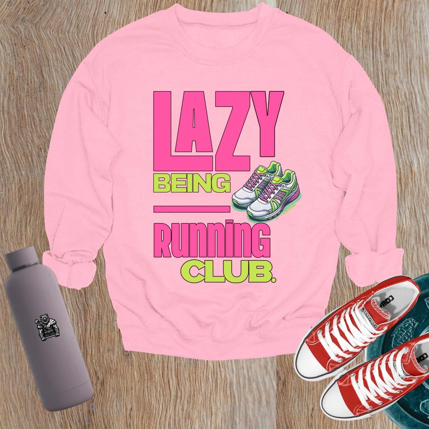 "Vibrant 'Lazy Being Running Club' sweatshirt featuring playful graphics, perfect for fitness enthusiasts and casual wearers at the gym."