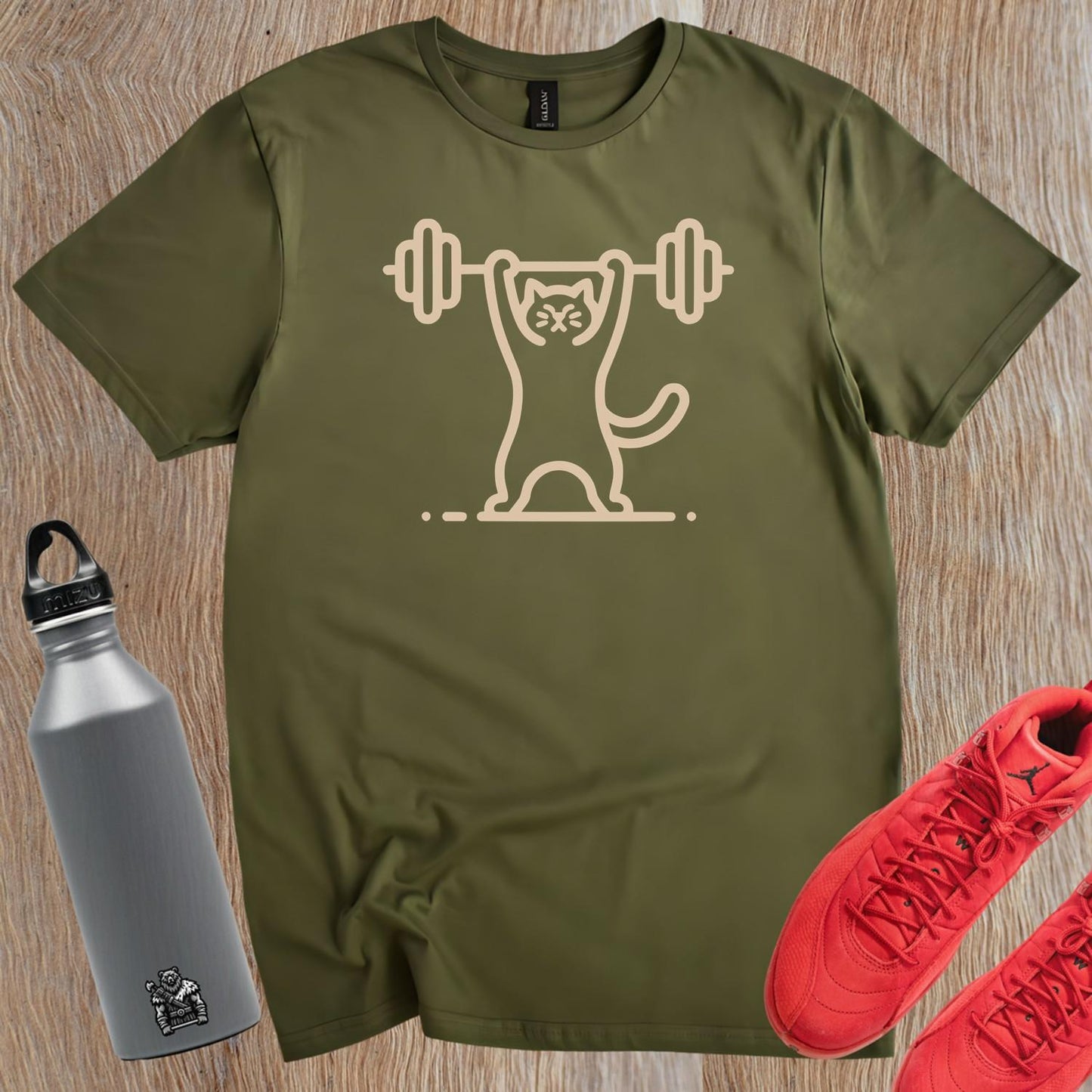 Alt text: "Funny Cat Lifting Weights T-shirt featuring a determined cat showcasing strength, perfect for fitness enthusiasts and gym lovers."
