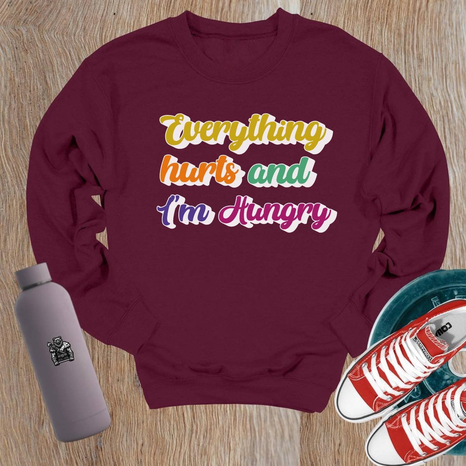 "Bold Crewneck Sweatshirt for gym-goers, featuring 'Everything hurts and I’m Hungry' in eye-catching design, perfect for workouts."