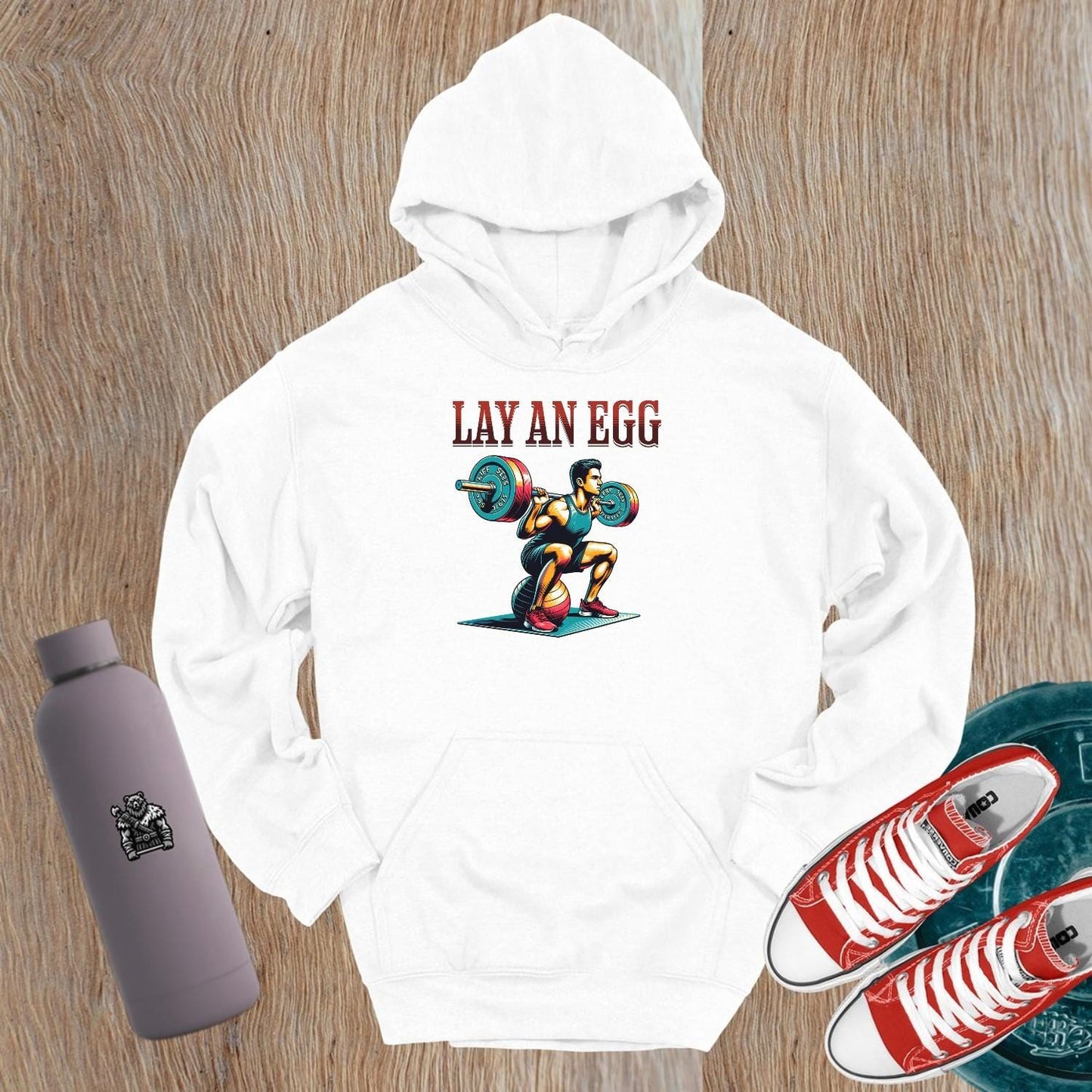 "Graphic gym hoodie featuring 'Lay an Egg' bold design, perfect for workouts and casual wear, inspiring strength and dedication."