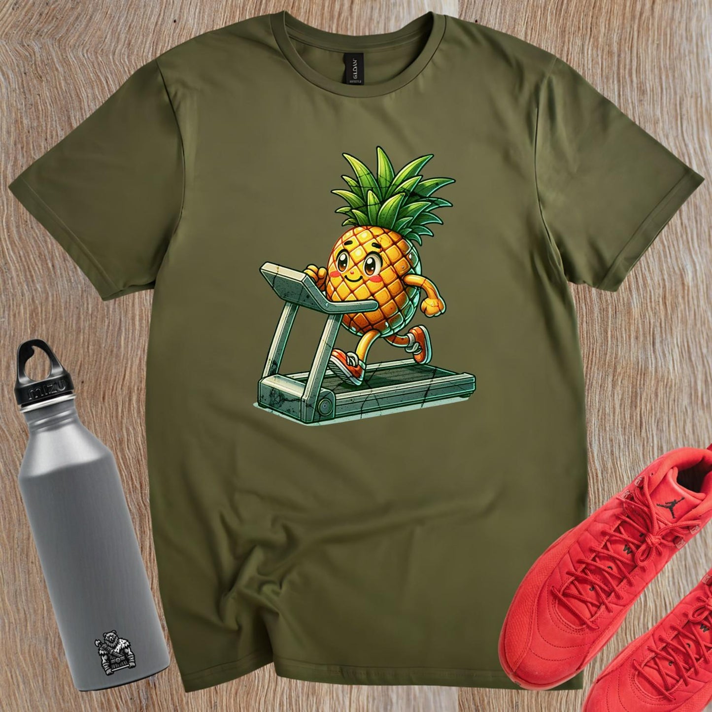 "Playful pineapple sprinting on a treadmill graphic T-shirt for gym enthusiasts; vibrant design enhances workout motivation and style."