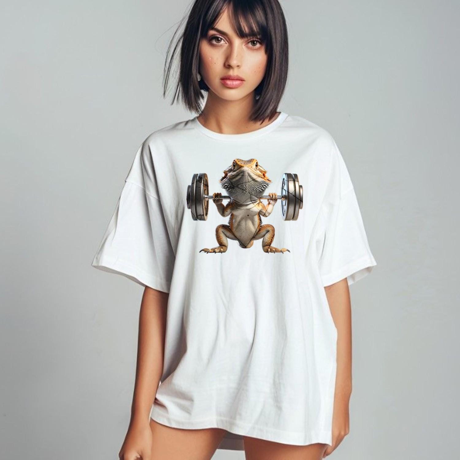 "Gym t-shirt featuring a vibrant lizard lifting weights, showcasing strength and individuality, ideal for gym enthusiasts and reptile lovers."