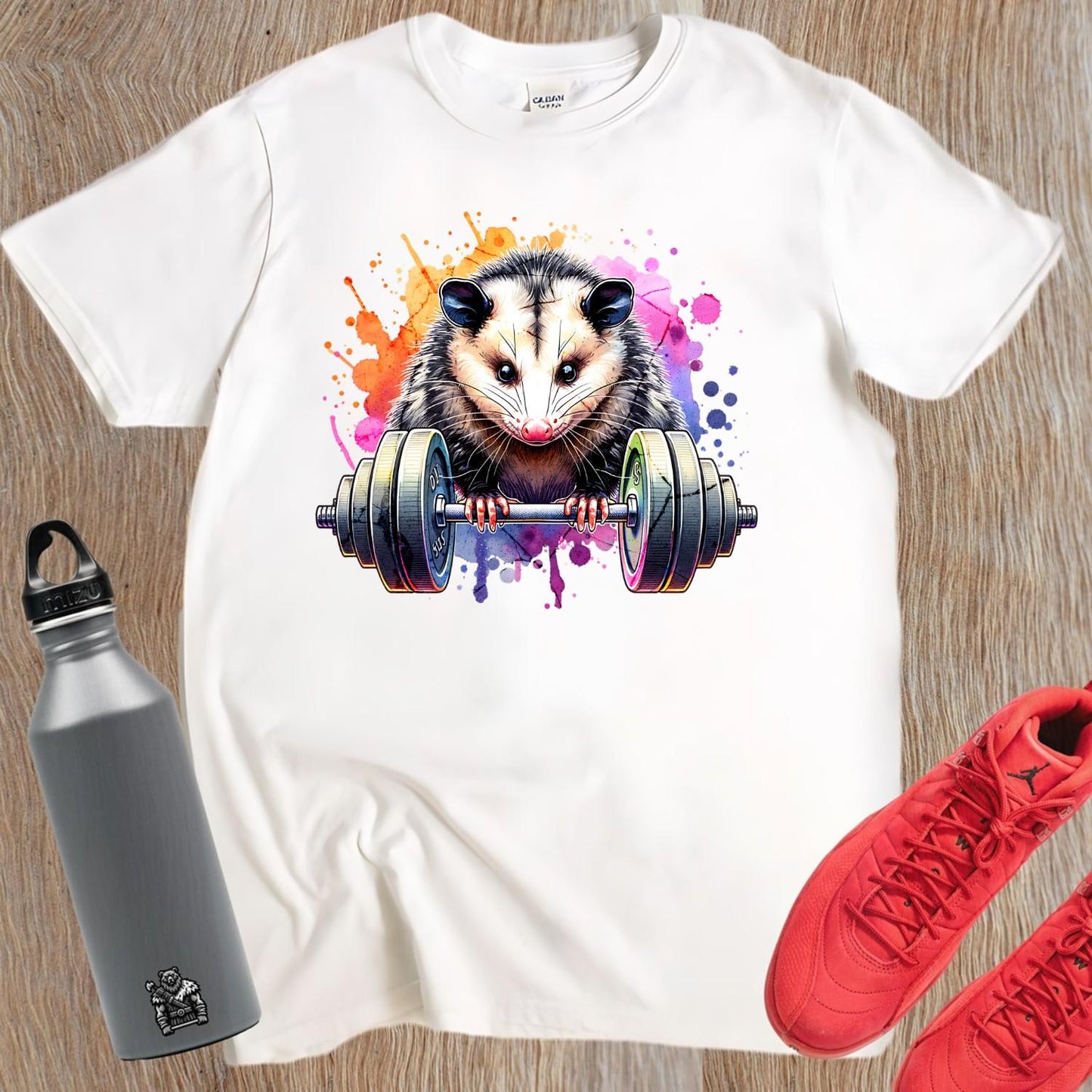 "Vibrant gym T-shirt featuring a fierce possum lifting weights, embodying strength and determination for fitness enthusiasts."
