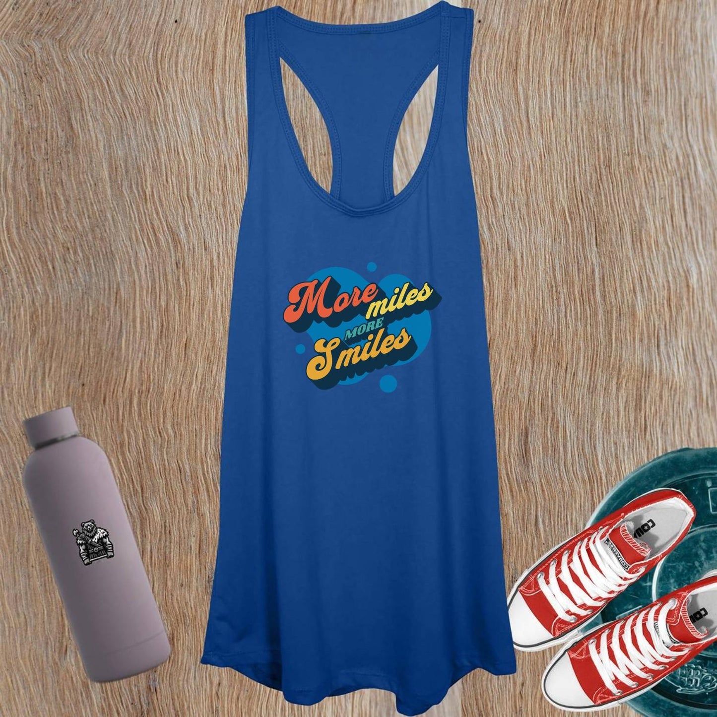 "Vibrant women's gym tank top featuring 'More Miles, More Smiles' motto, perfect for workouts and casual outings. Stylish design."