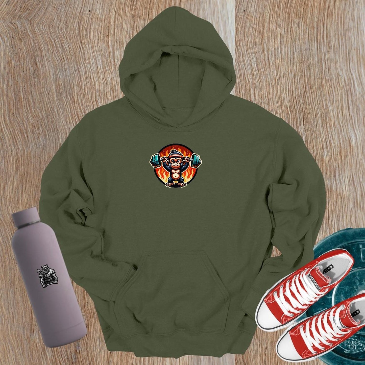 "Dynamic gym hoodie featuring a muscular monkey lifting weights against a fiery backdrop, showcasing style and strength for fitness enthusiasts."
