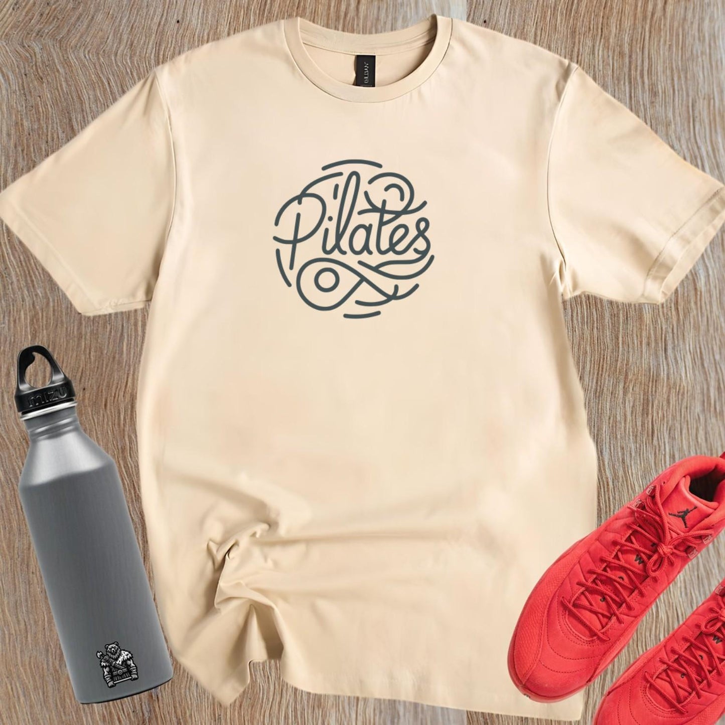 Stylish Pilates T-shirt featuring a modern logo, tailored for comfort and movement, ideal for workouts and casual outings.
